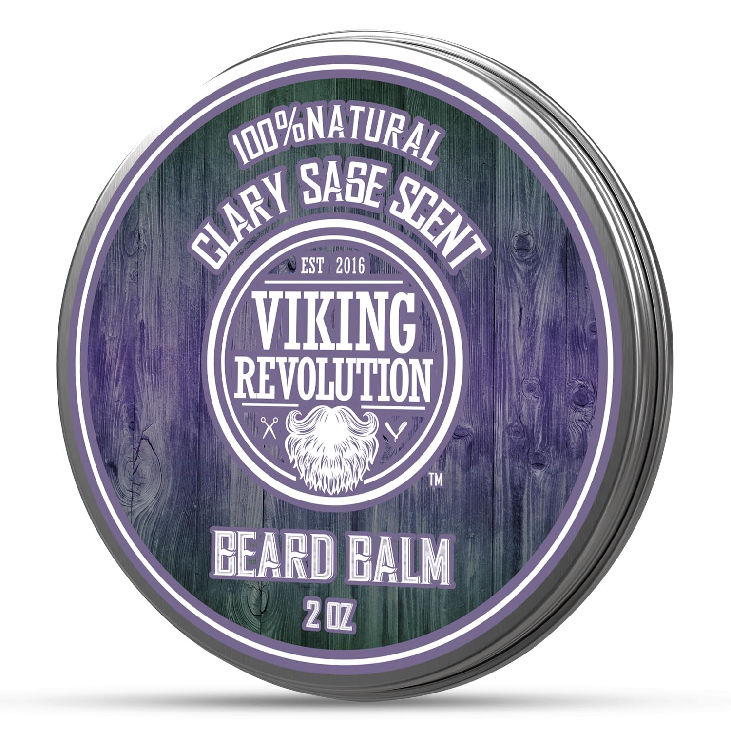 Round tin labeled Beard Balm by Viking Revolution, made with natural ingredients. The clary sage scent complements the purple and green rustic design, providing excellent beard conditioning.