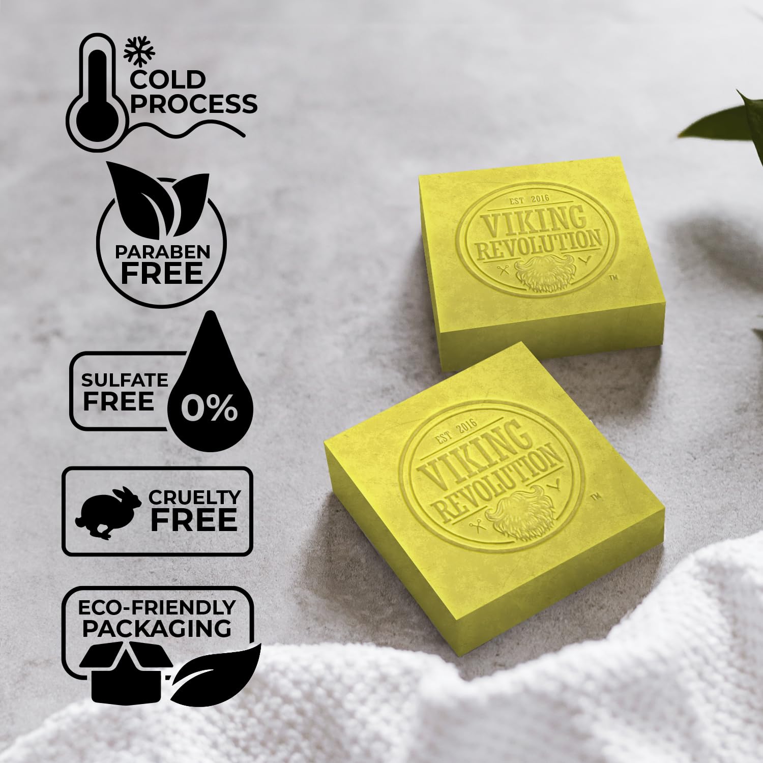 Two yellow bars of Bergamot Natural Soap for Men on a surface with eco-friendly icons to the left.