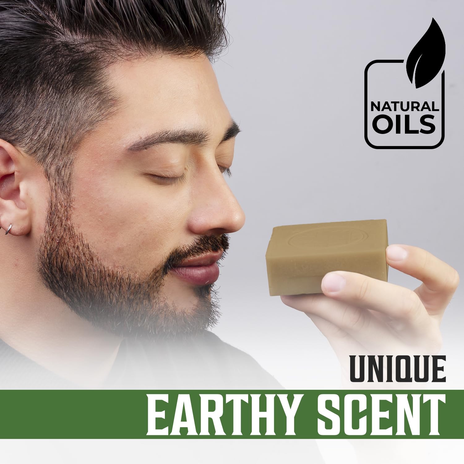 Man holding Vetiver Natural Soap for Men, cold pressed, with a unique earthy scent and natural oils.