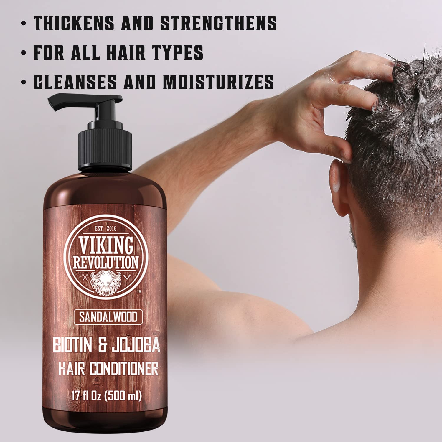 A man applies the Sandalwood Conditioner with Biotin and Jojoba Oil, expertly designed for all hair types to ensure optimal benefits for healthy and nourished locks.