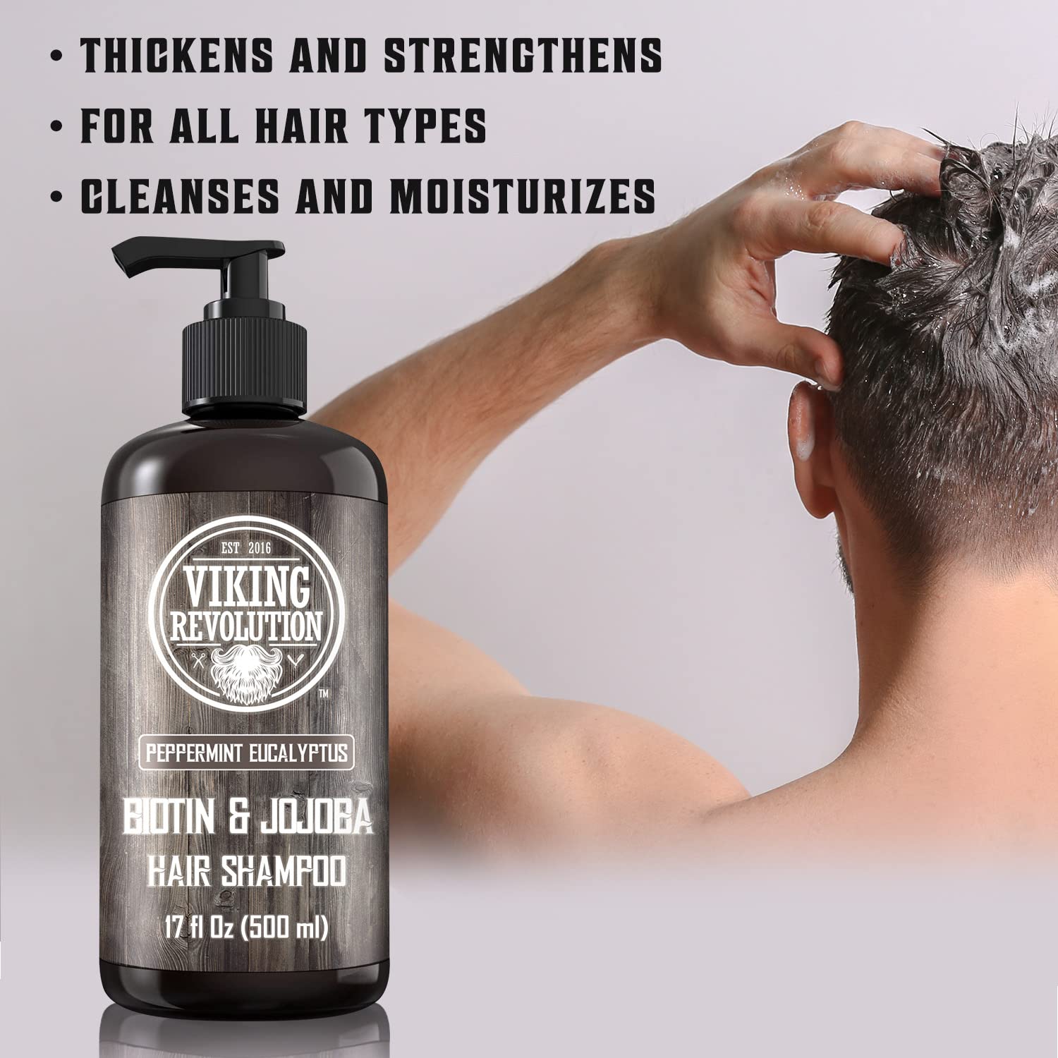 Person shampooing with Eucalyptus and Peppermint Shampoo -17oz bottle in foreground.