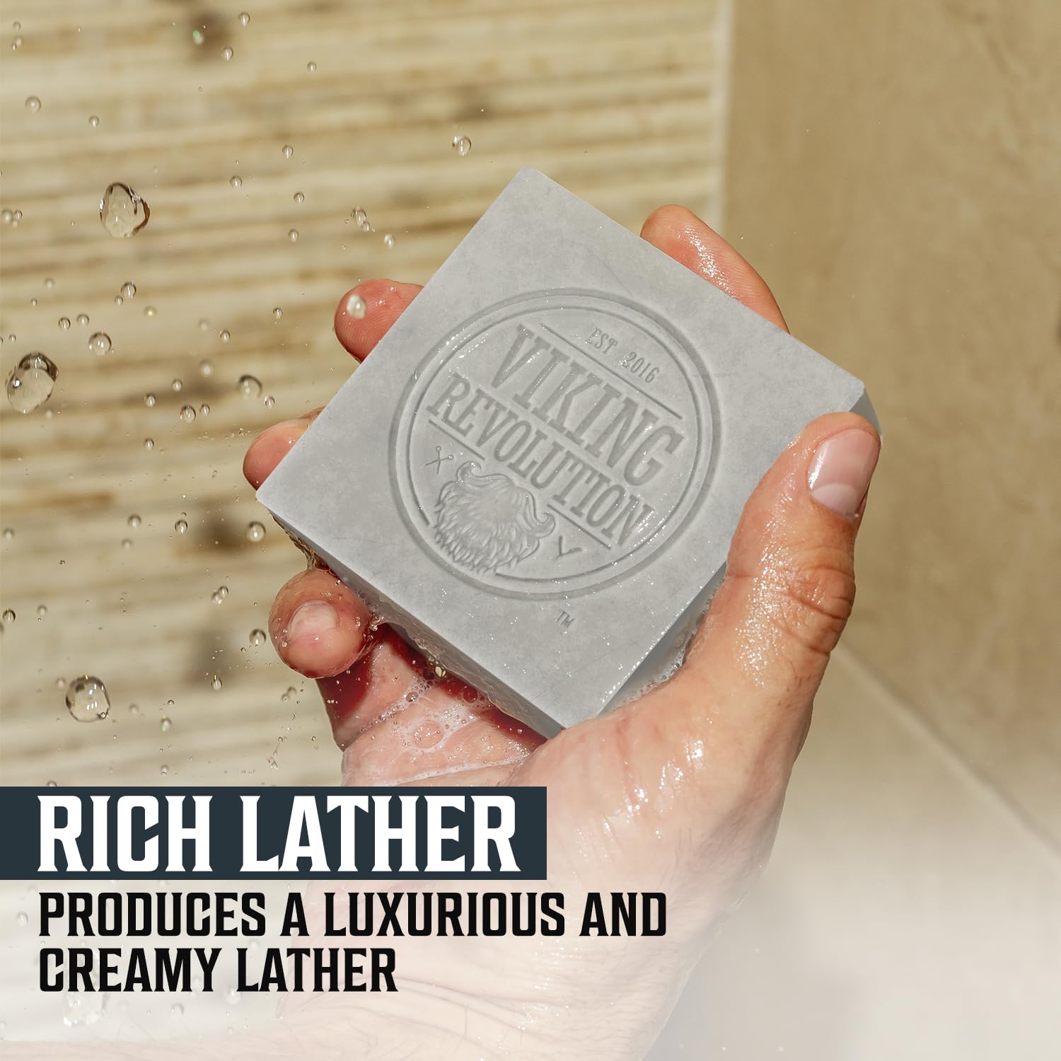 In a shower, a hand holds the Peppermint Natural Soap for Men - Cold Pressed Bar Soap for Men 2pk under running water, producing a rich, creamy lather. This men's bar soap is free from sulfates and parabens, guaranteeing a refreshing cleanse without harsh additives.