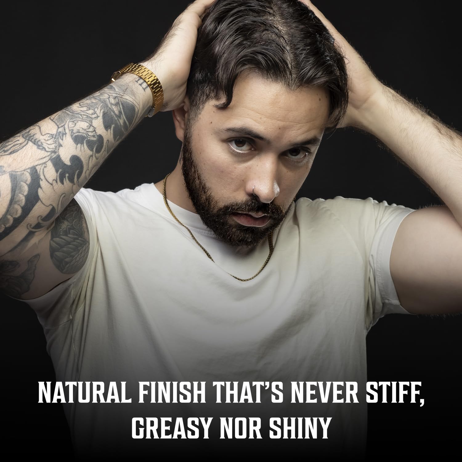 Man styling hair with hands, white shirt; text: Natural finish with our sandalwood hair paste for men.