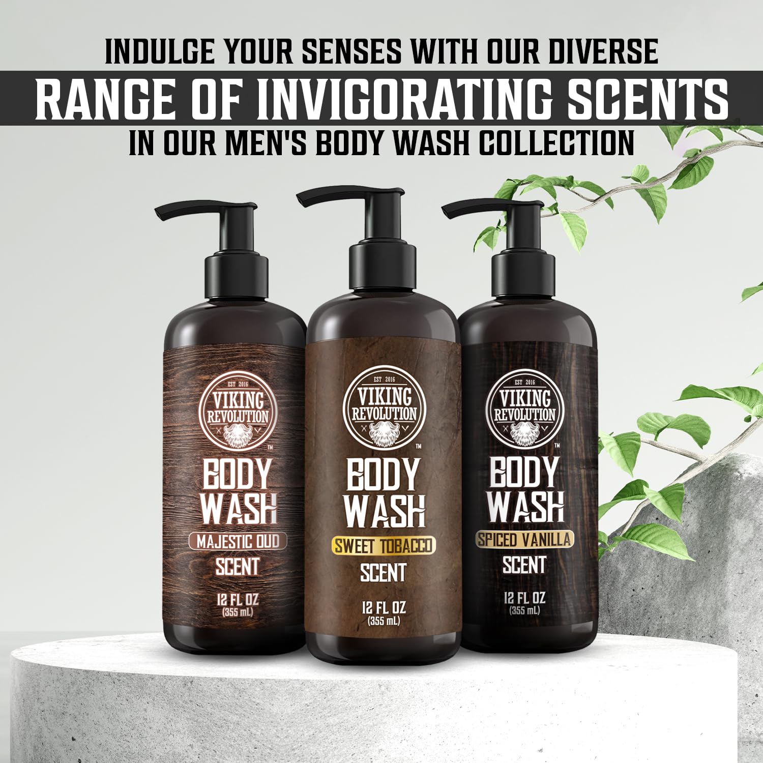 Two bottles of the Body Wash - Majestic Oud 2 pack by Viking Revolution are placed on a white surface, accompanied by green leaves.