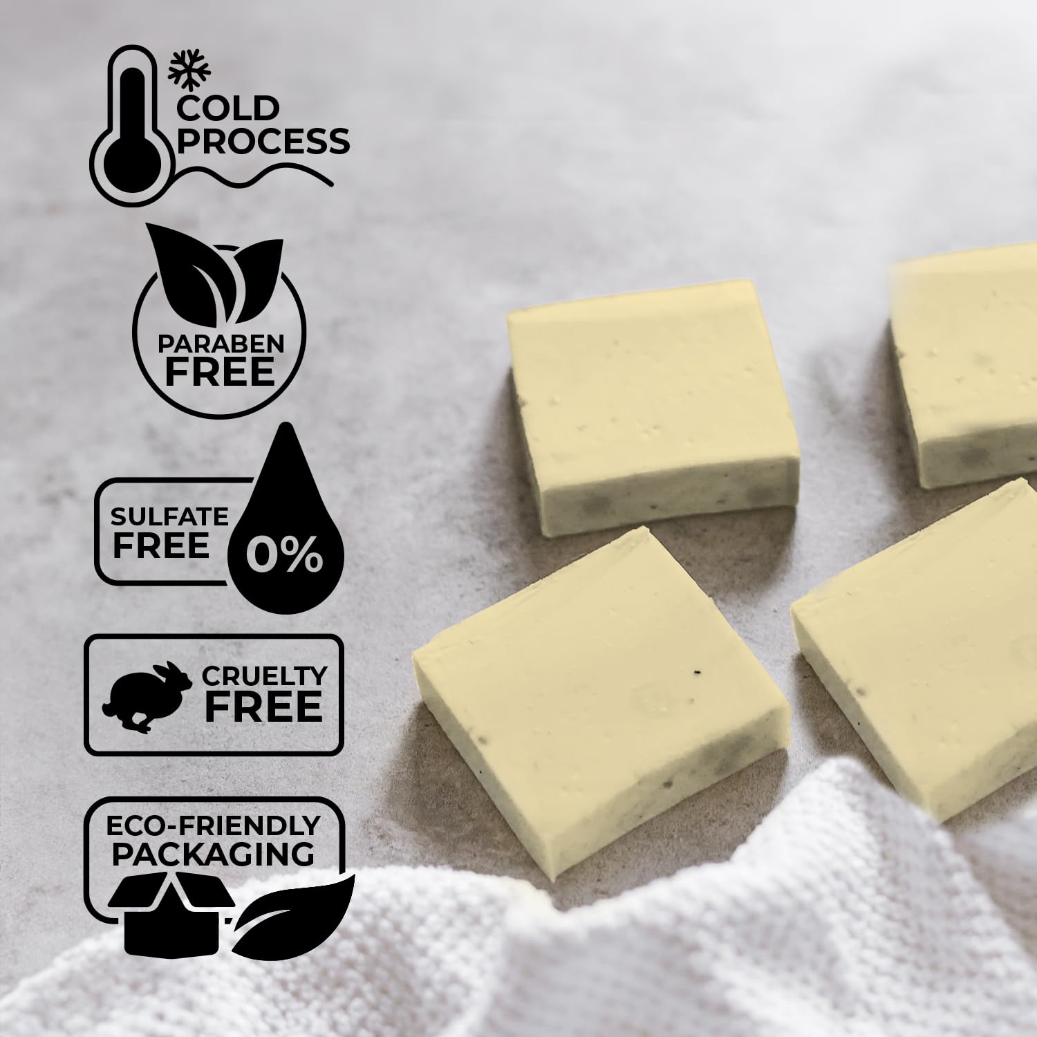 Two packs of mens Tea Tree soaps, eco-friendly with skin-soothing sandalwood notes, lie on a towel.