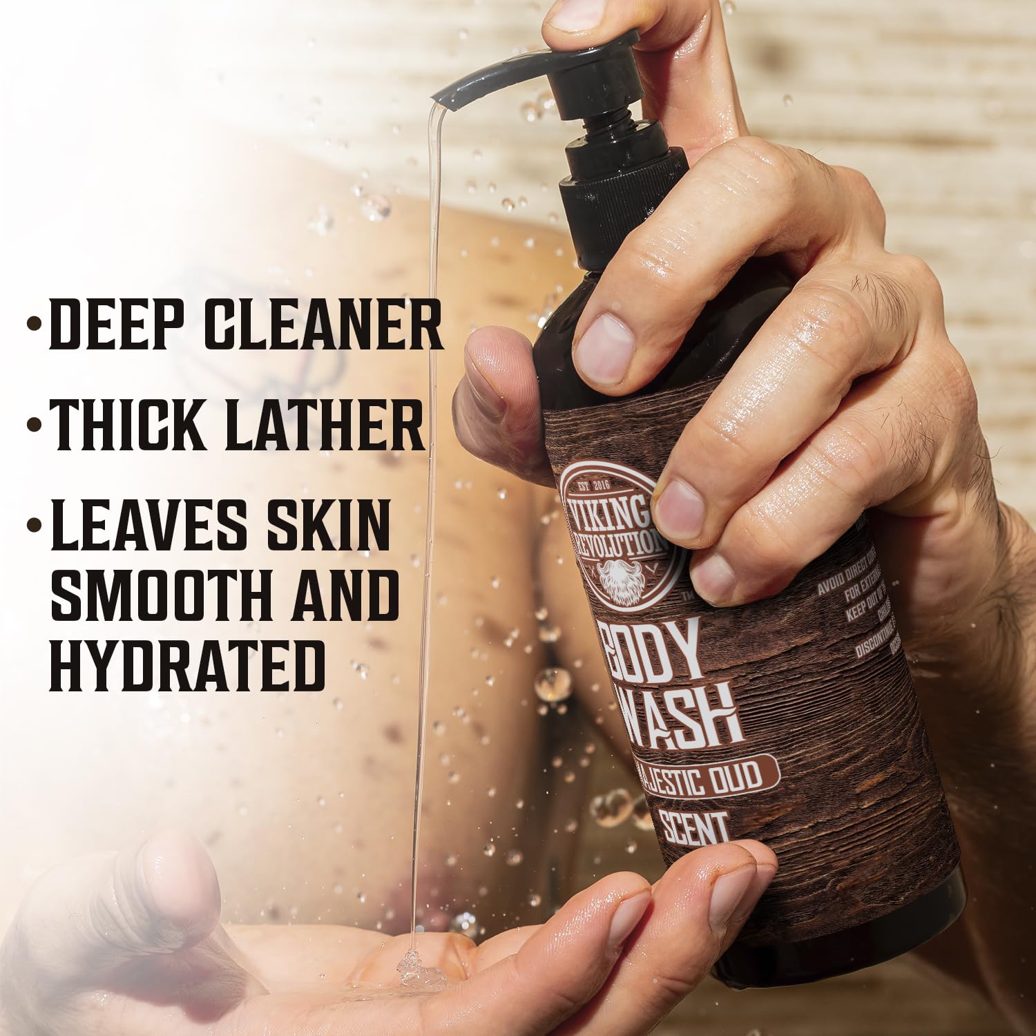 A hand holds a bottle of Body Wash - Majestic Oud from a 2-pack, as the liquid gracefully spills onto the palm, with text detailing product benefits visible on the side.