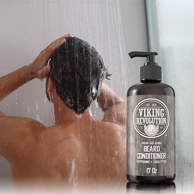 Person showering with a Beard Conditioner 17oz bottle in the foreground, embracing healthy beard growth through its natural beard oil-infused formula.