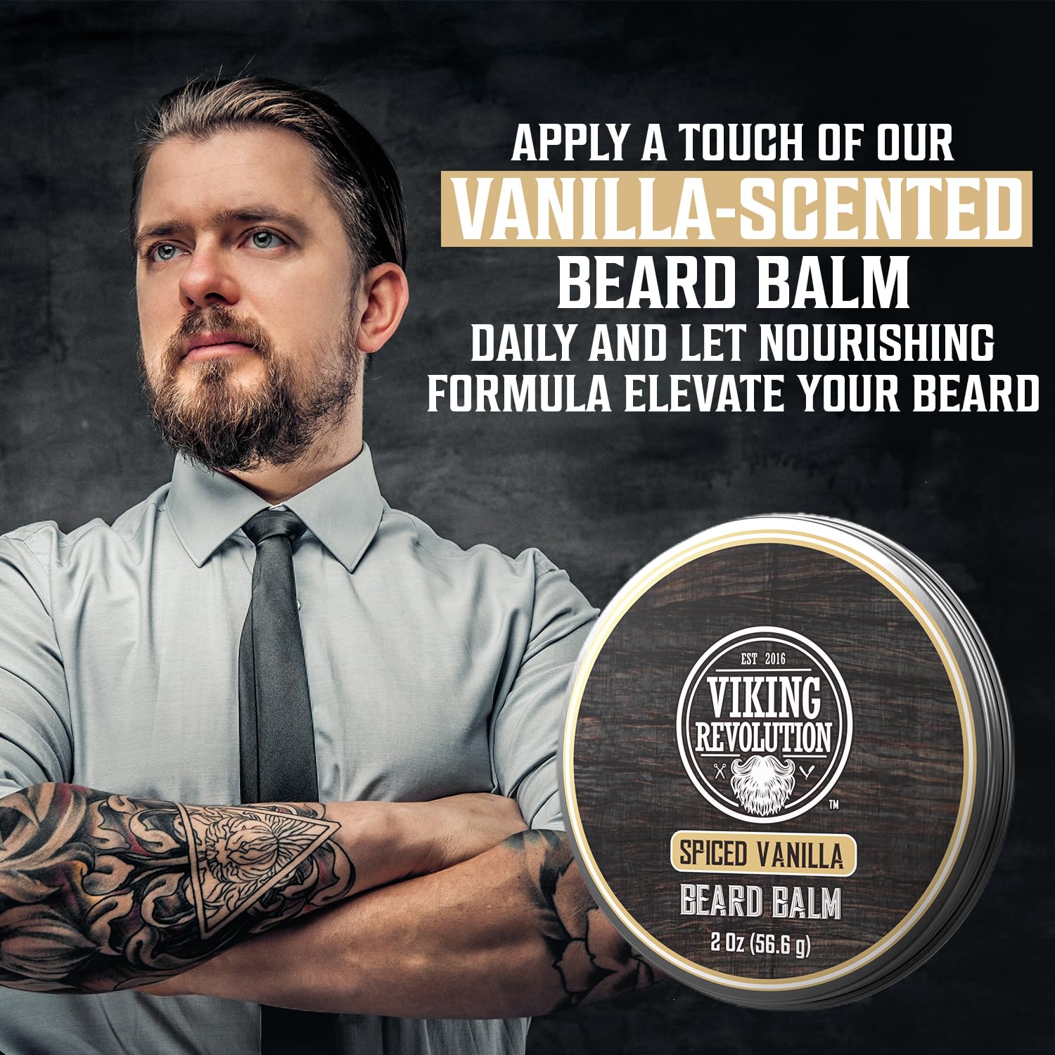 Tattooed man holding jar of Beard Balm - Spiced Vanilla 2oz, showcasing natural beard care.