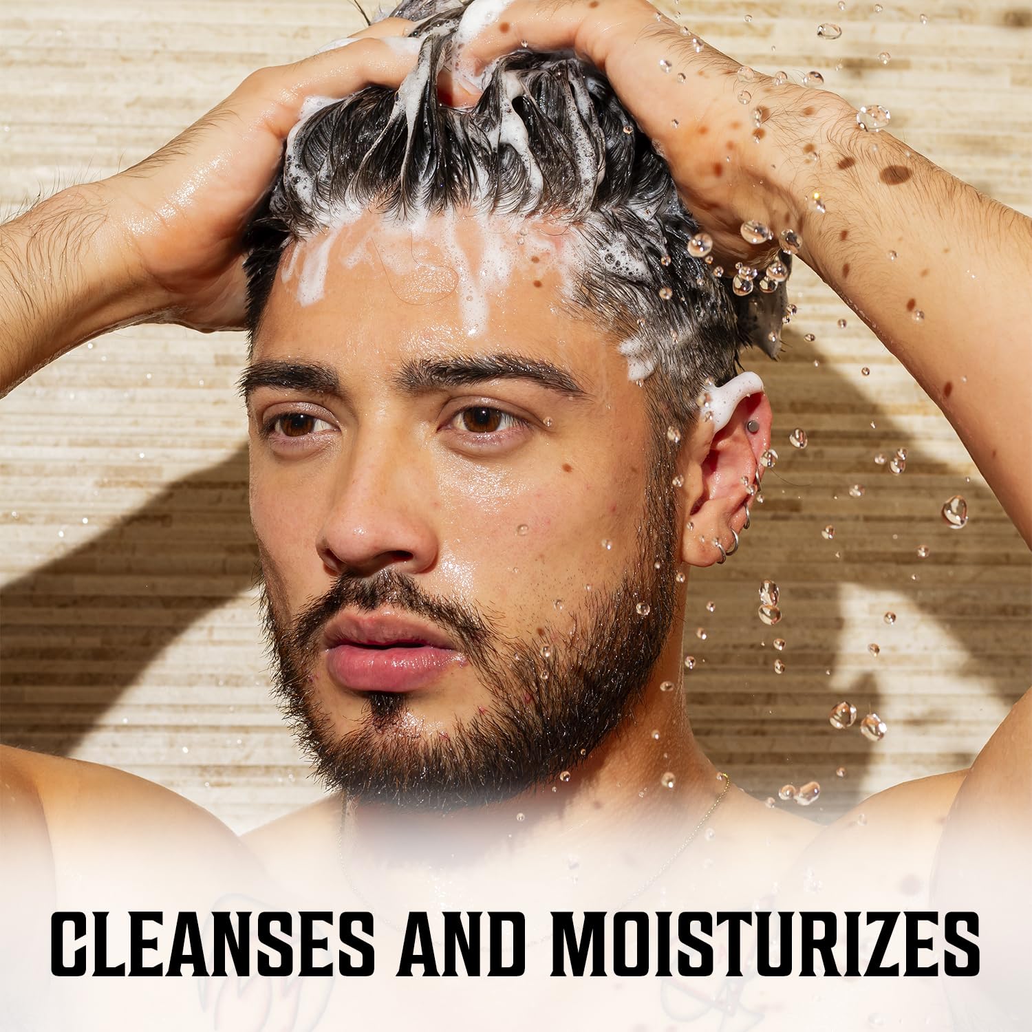 Person using Majestic Oud Hair Shampoo & Conditioner: Cleanses and moisturizes.
