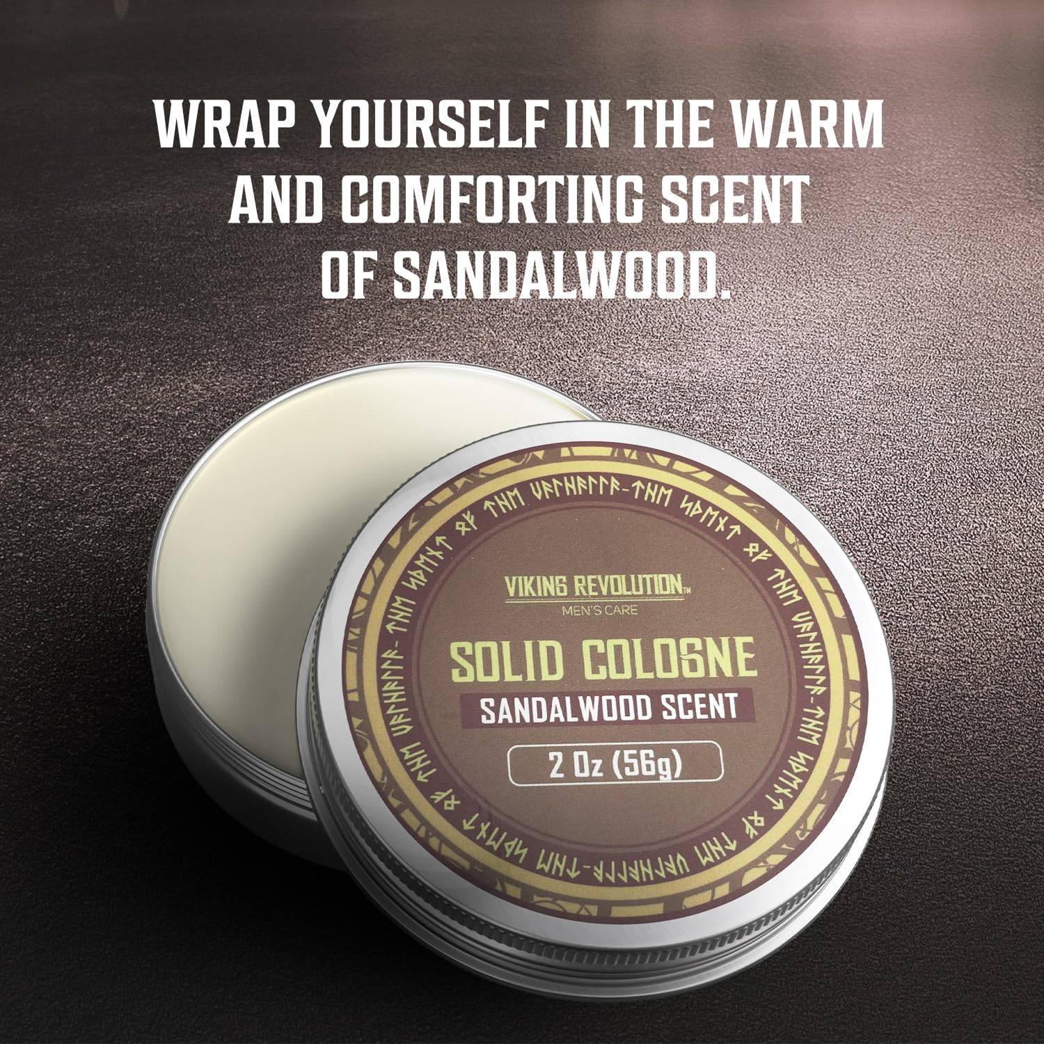 Tin of Solid Cologne 2 Oz Sandalwood—a manly scent by Viking Revolution—sits on a dark surface.