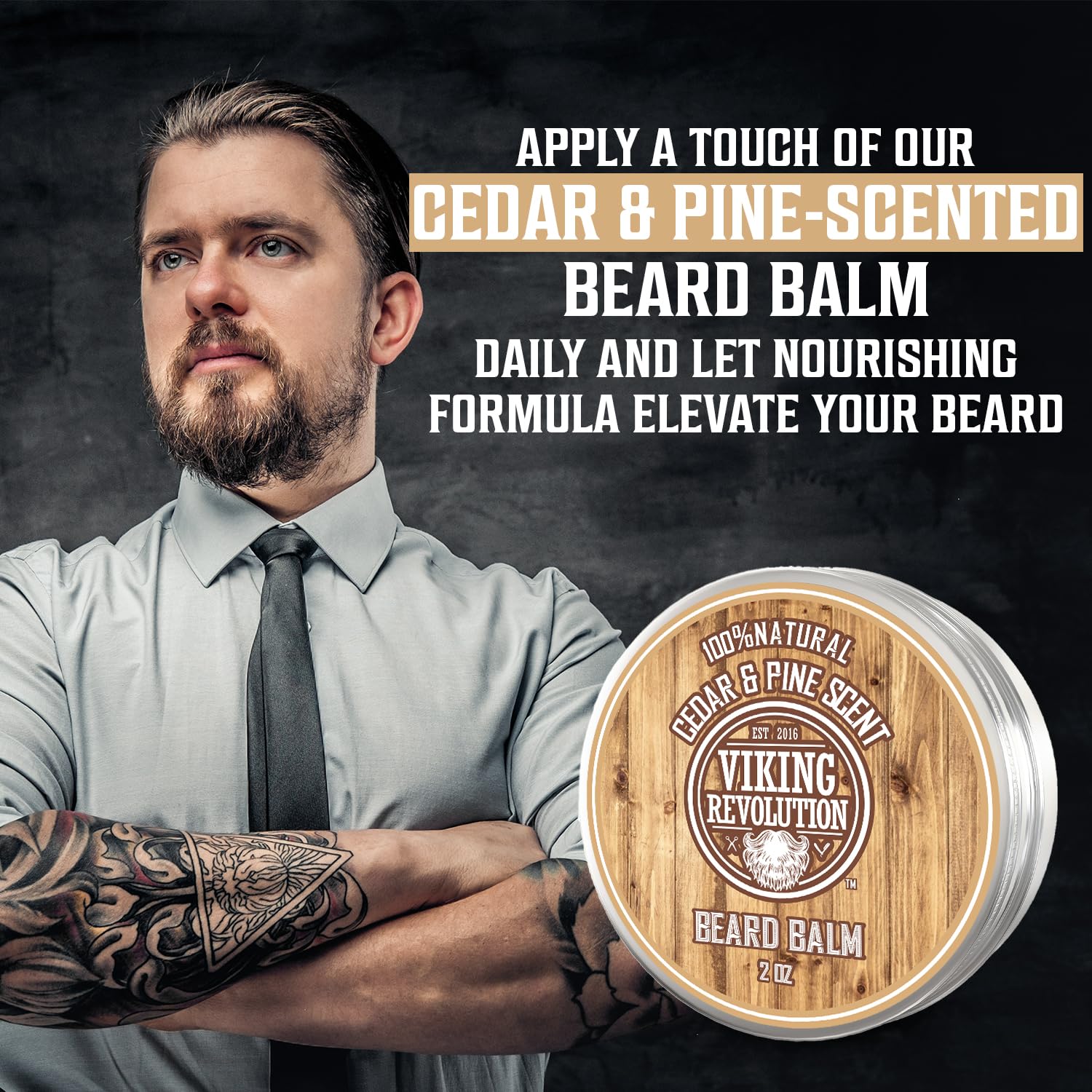 A tattooed bearded man is promoting the Cedar & Pine Beard Balm, crafted with organic ingredients. This balm moisturizes your beard while enveloping it in a captivating woodsy scent of cedar and pine.