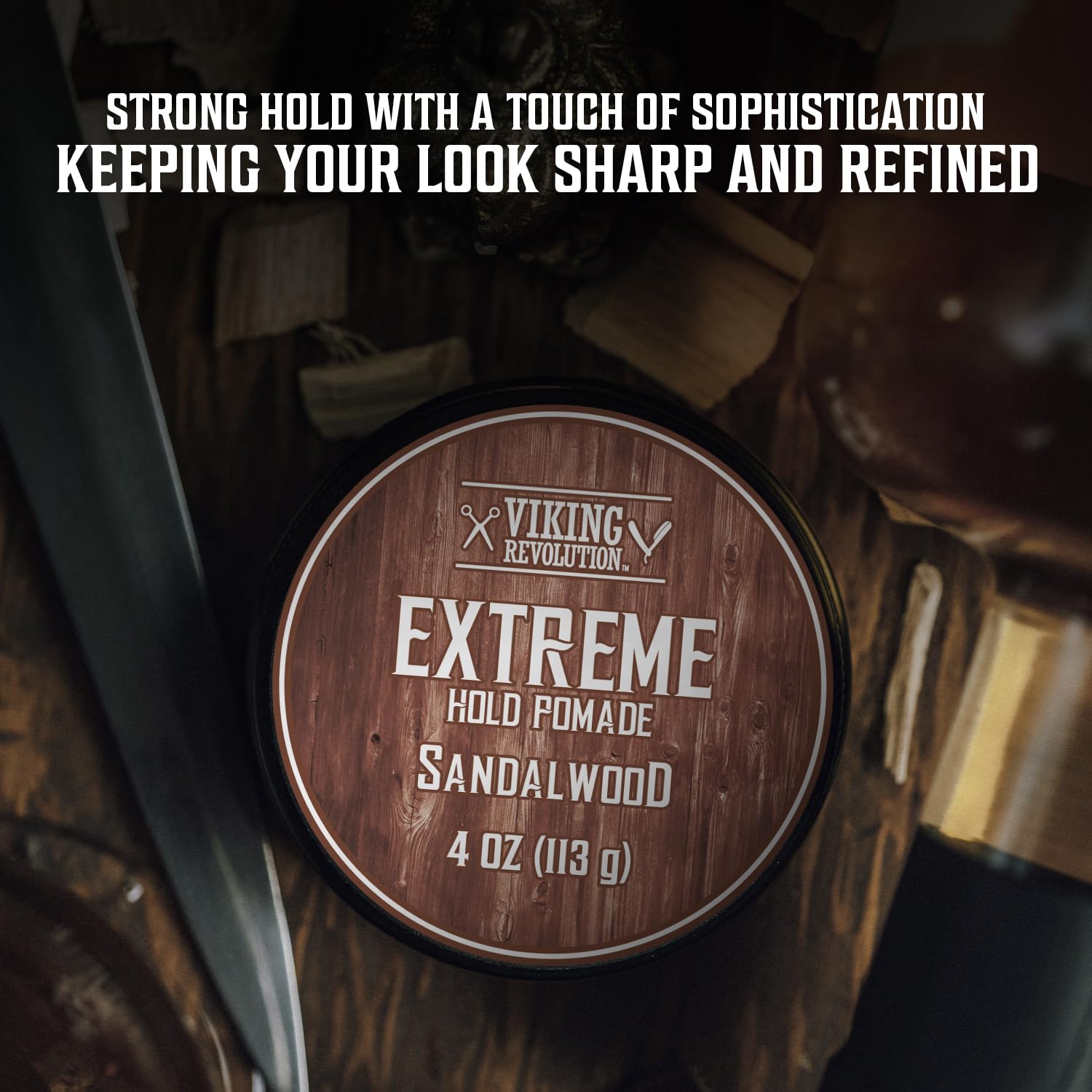A tin of Sandalwood Hair Pomade (4 oz) sits on a dark wooden surface.