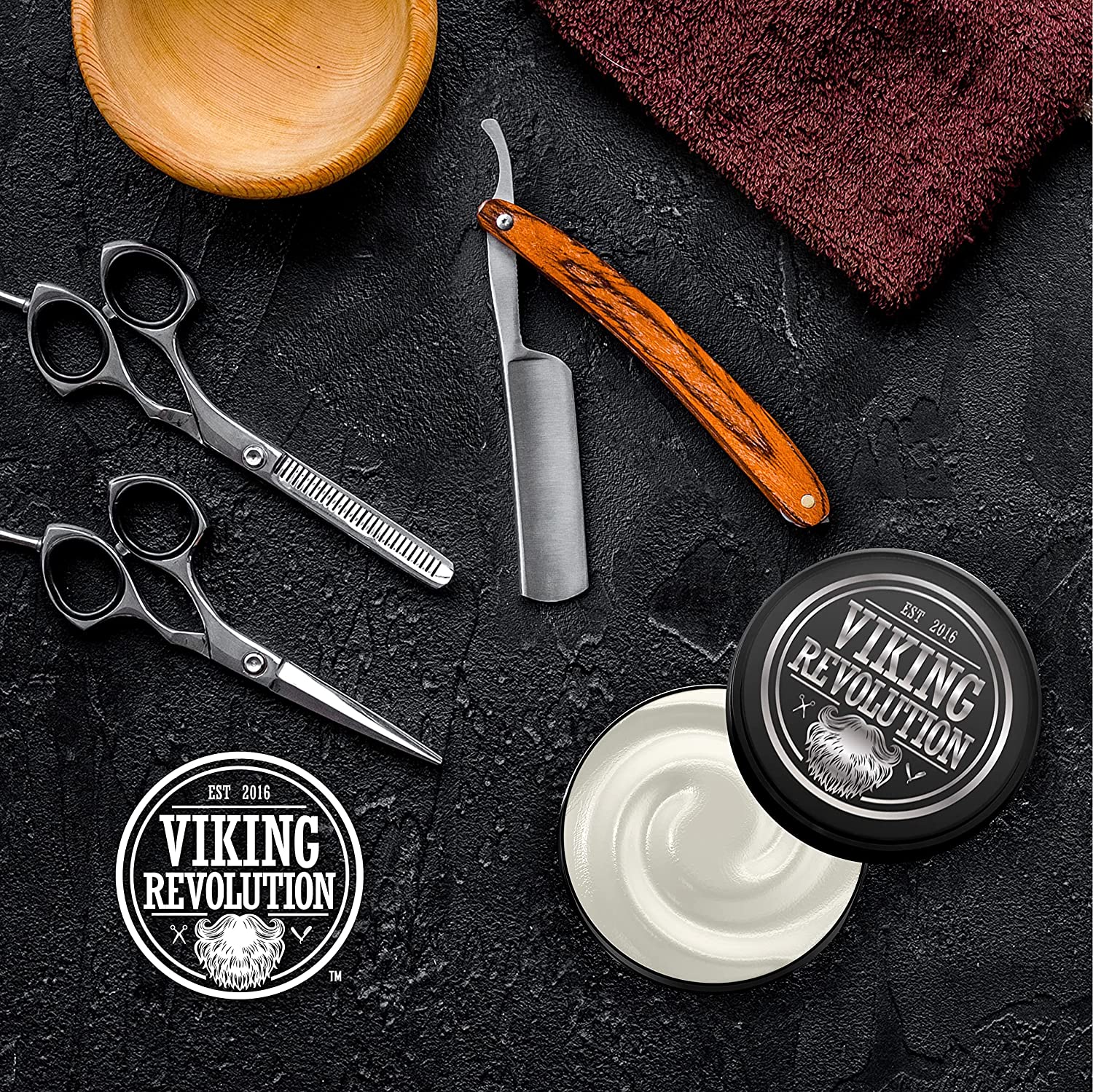 Viking Revolution Sandalwood Shaving Cream 5.3oz, part of a beard grooming set with scissors, razor, and bowl on a dark surface, is enriched with natural sandalwood oils to provide a smooth shave for sensitive skin.