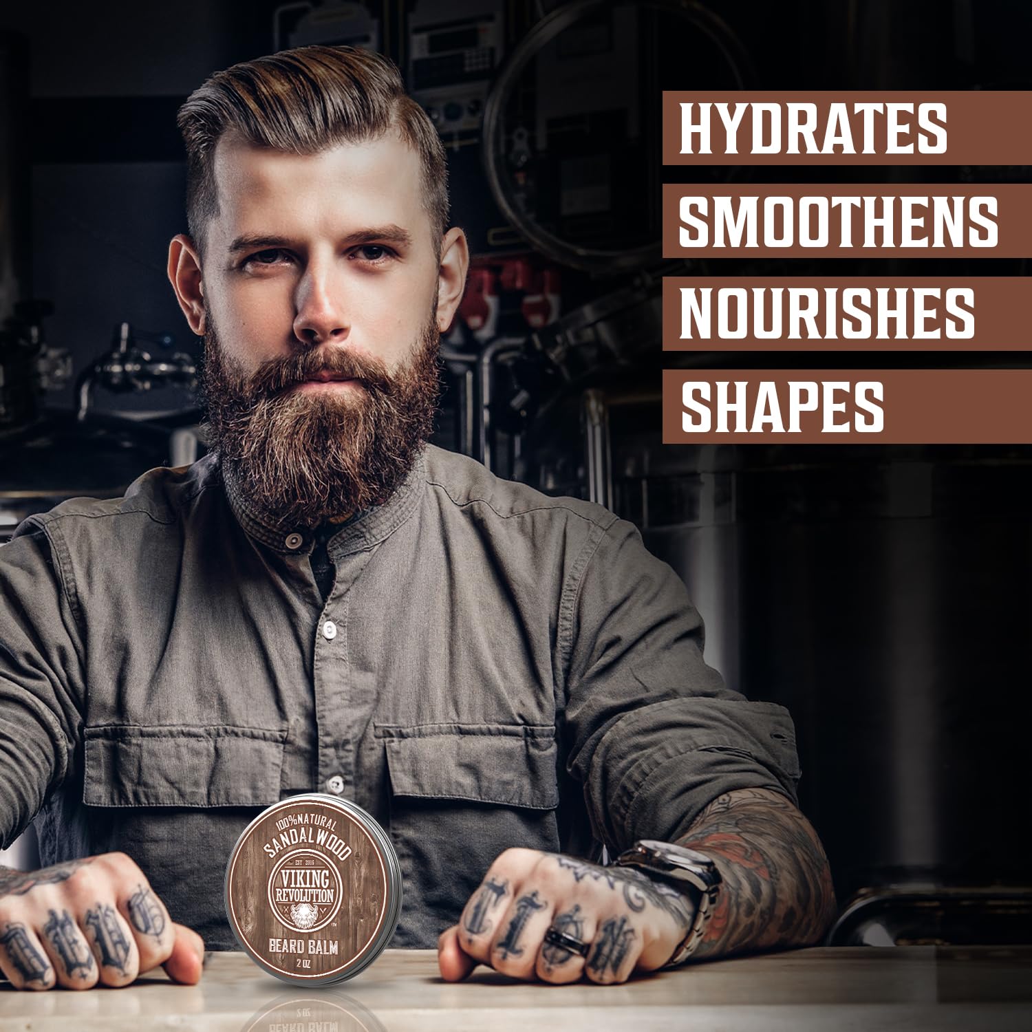 Tattooed man in workshop promotes Sandalwood Beard Balm; hydrates, shapes, and nourishes with natural ingredients.