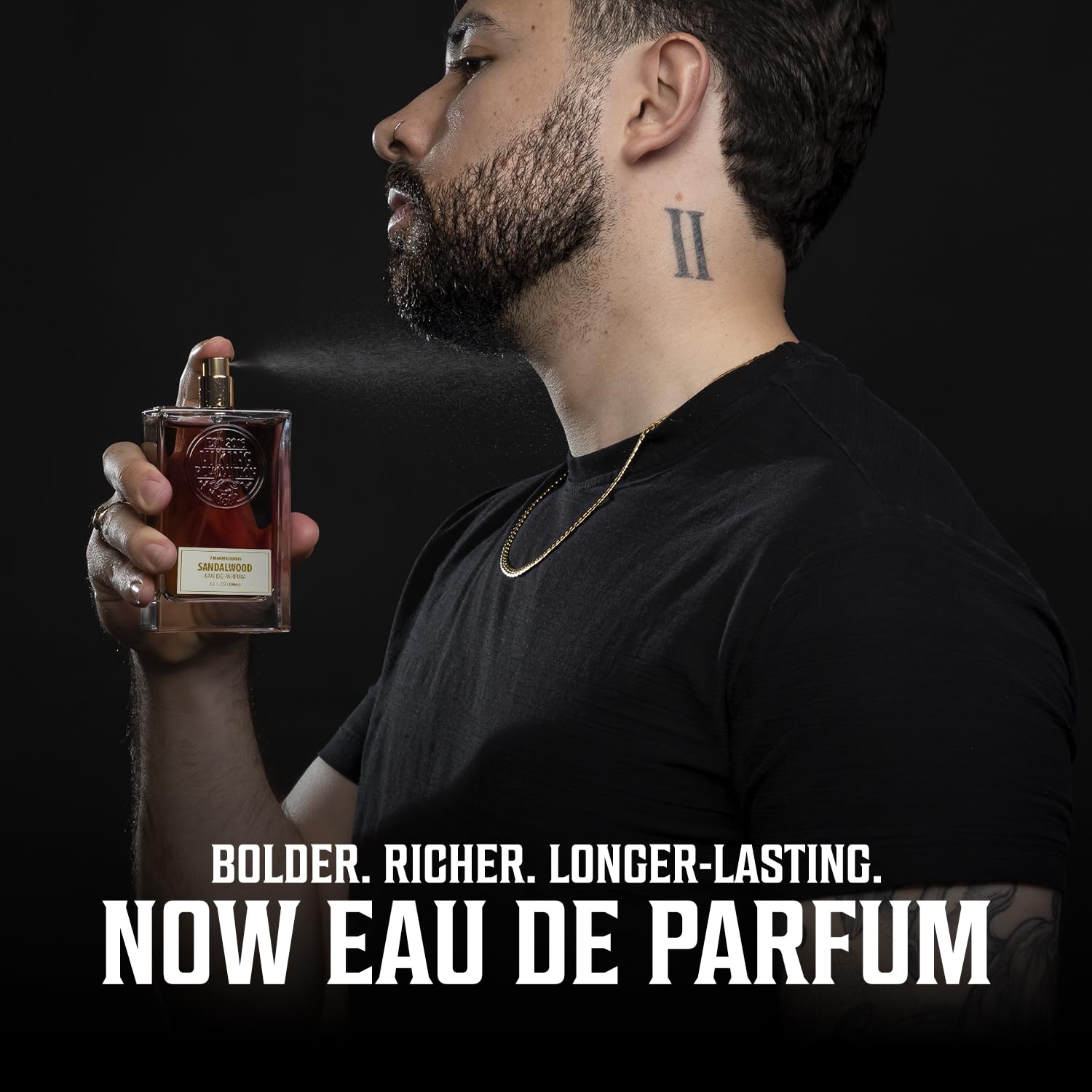 A man sprays Sandalwood Perfume (3.5 Fl Oz) on his neck: Bolder. Richer. Longer-lasting Eau De Parfum.
