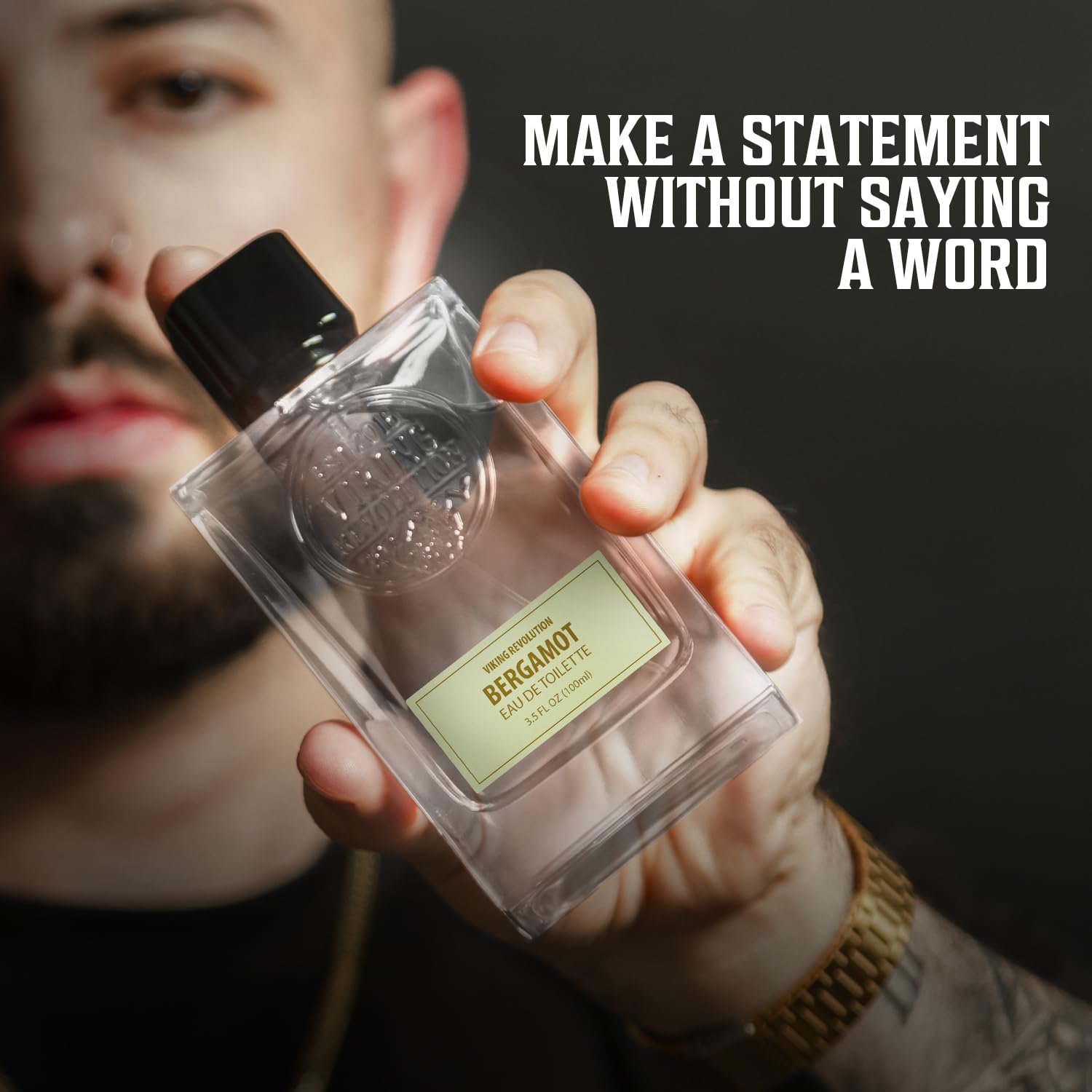 Person holding Cologne for Men 3.5 fl oz bottle, bold text says MAKE A STATEMENT WITHOUT SAYING A WORD, akin to the irresistible allure of Viking Revolution's Sandalwood Cologne.