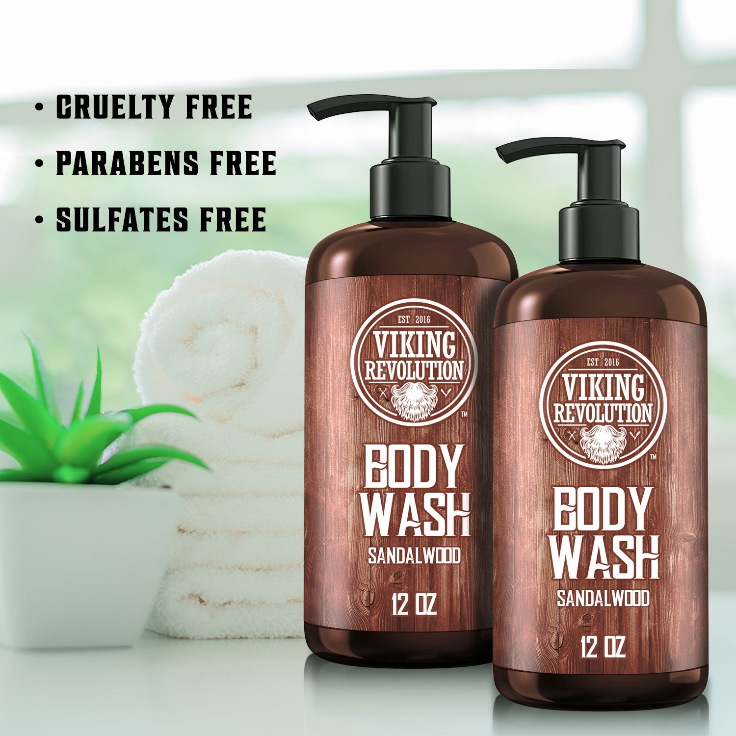 The Sandalwood Body Wash - 2 Pack, proudly showcasing the Cruelty Free label, is nestled alongside a plush towel and a vibrant plant, offering an ideal blend of skincare luxury and ethical commitment.