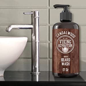 Bottle of Beard Wash 17oz with natural ingredients beside a modern sink.
