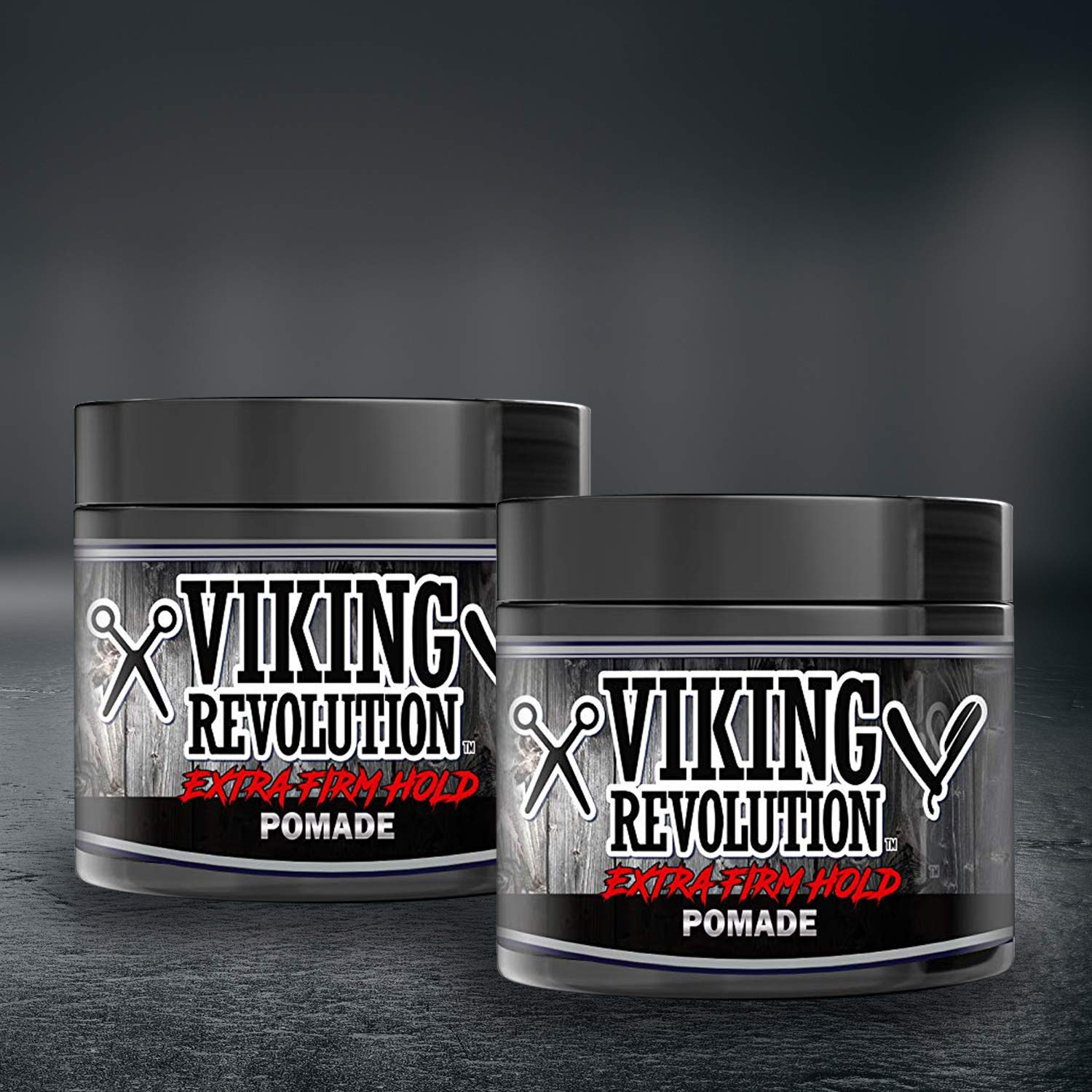 A 2-pack of Pomade, featuring natural ingredients, provides extra-firm hold against a dark background—ideal for all your hair grooming needs.