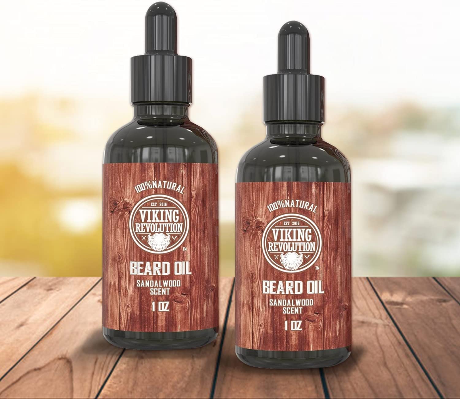 A pair of Sandalwood Beard Oil bottles from the 2-pack set sits on a wooden surface, offering a frizz-free beard experience.