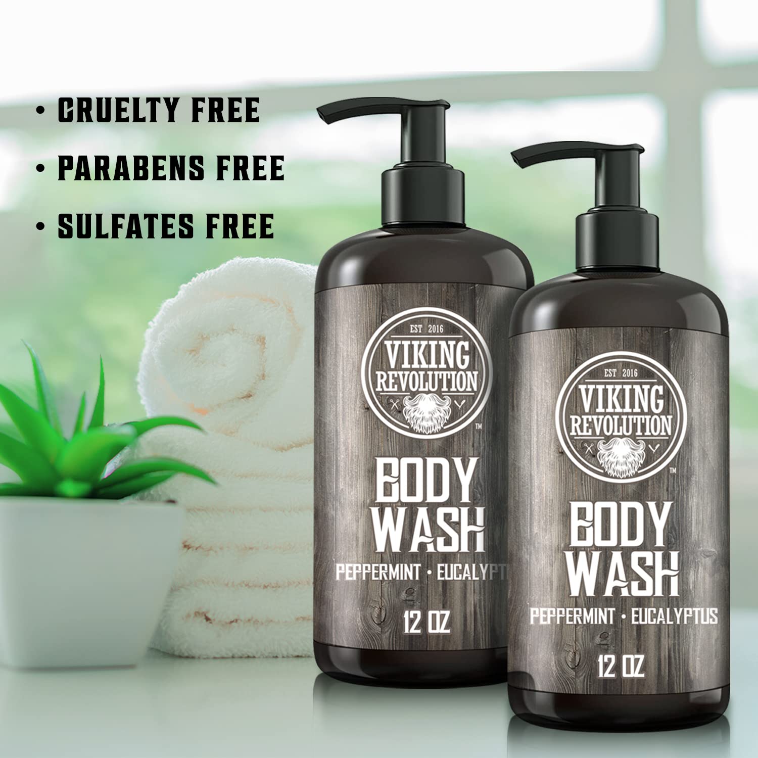 Two bottles of the Peppermint Eucalyptus Body Wash - 2 Pack from Viking Revolution, designed for men's skincare, are accompanied by a rolled towel and a plant. Each cruelty-free, paraben-free, and sulfate-free bottle offers an invigorating blend of peppermint and eucalyptus.