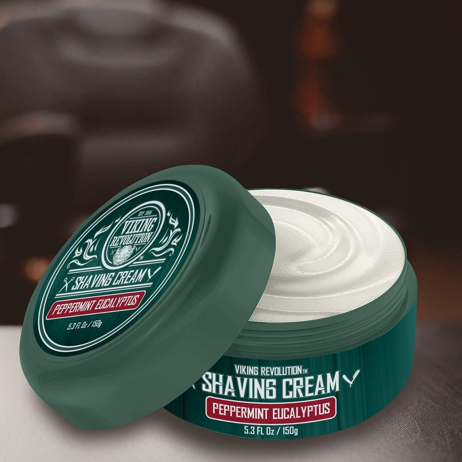The open container of Peppermint & Eucalyptus Shaving Cream promises an invigorating shaving experience with its refreshing scent, resting elegantly on the tabletop.