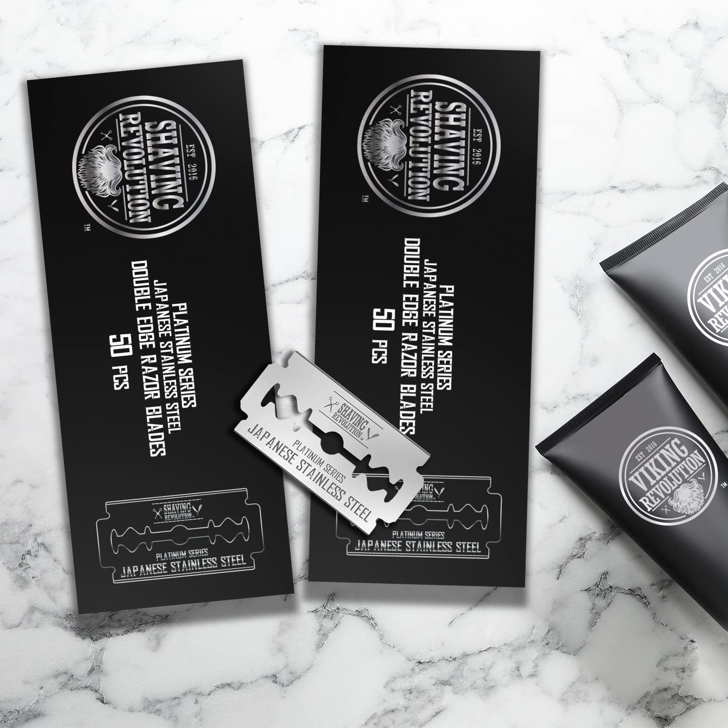 Sleek Double Edge Razor Blades (100 Count) with safety razor accessories rest on a marble surface, showcasing precision Japanese stainless steel for the sharpest edging blades.