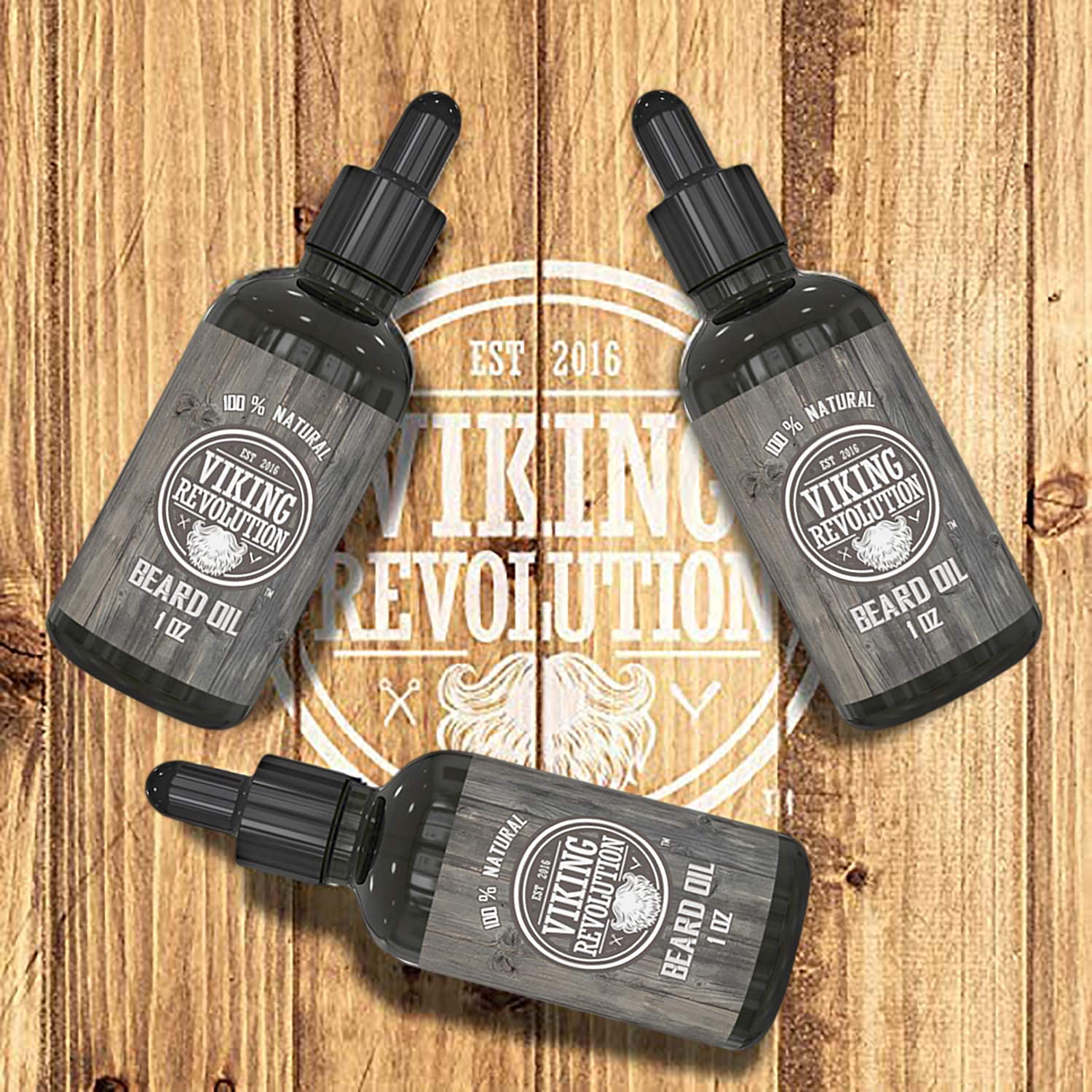 The Unscented Beard Oil - 3 Pack, crafted by Viking Revolution and enriched with Organic Jojoba Oil, rests elegantly on a wooden background, with the logo proudly centered.