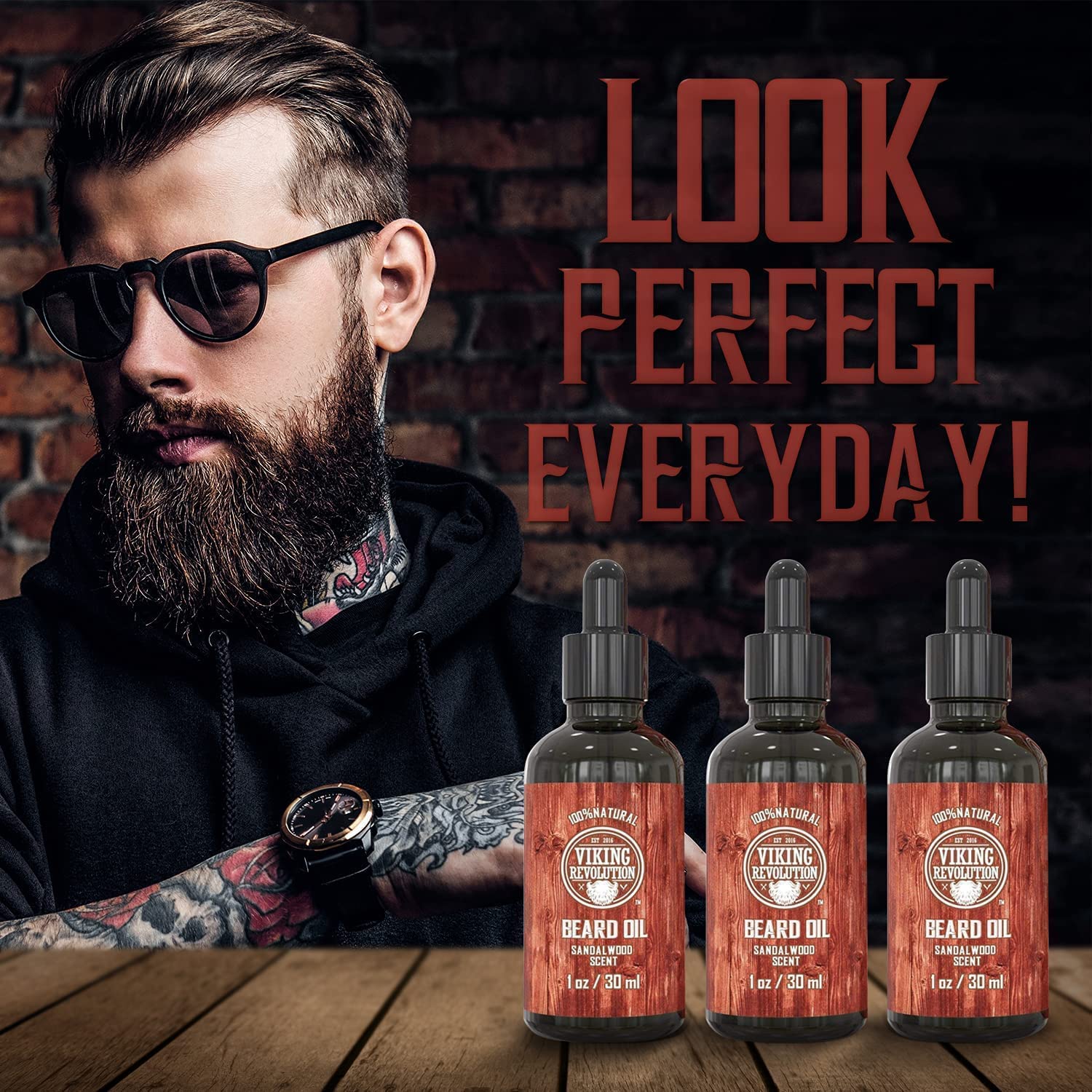 A bearded man in sunglasses is holding bottles from the Sandalwood Beard Oil - 3 Pack; text reads Look Perfect Everyday with 100% Natural Ingredients!