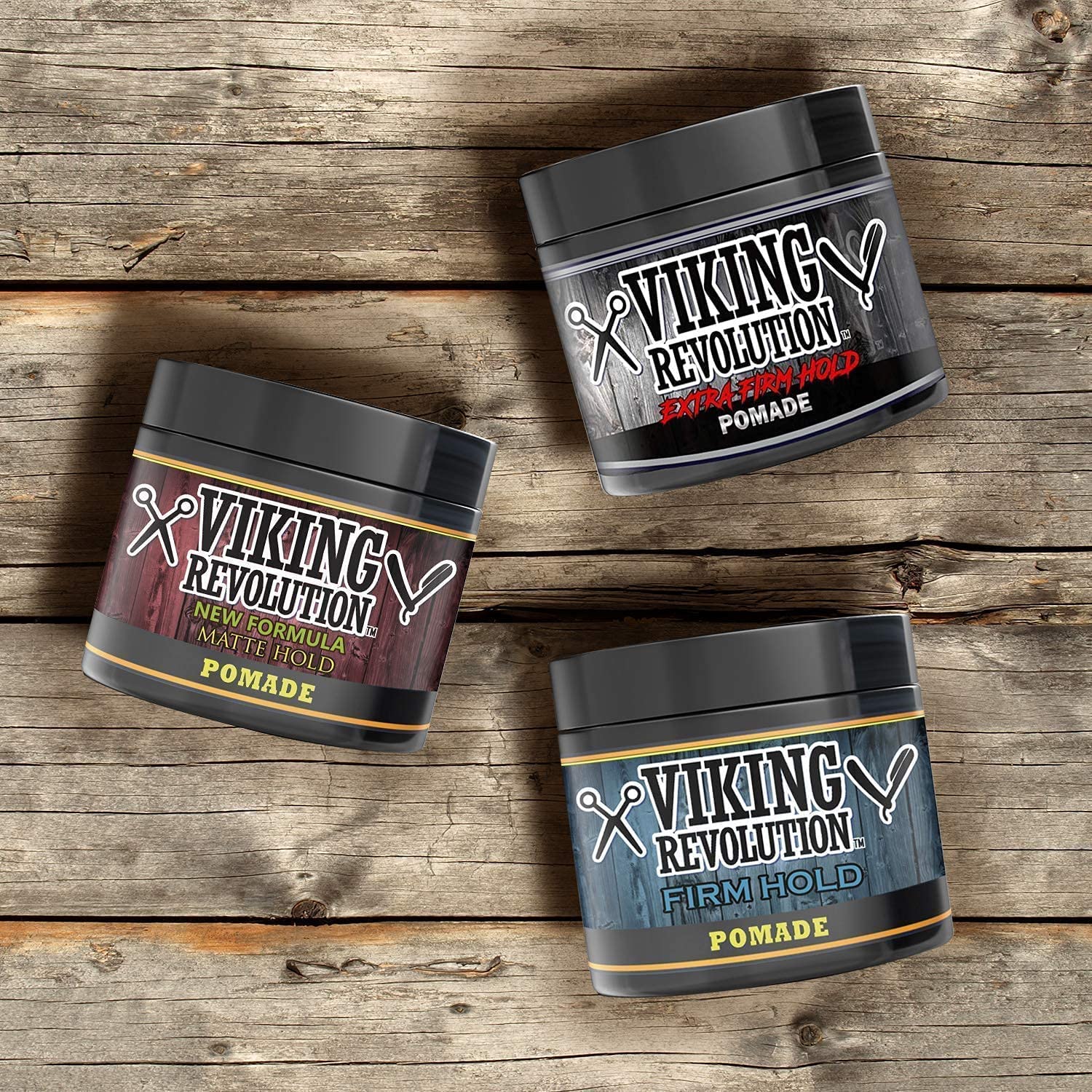 Three jars from the Hair Pomade Mix - 3 Pack are elegantly arranged on a wooden surface, ready to transform any hairstyle with the power of authentic Viking style.