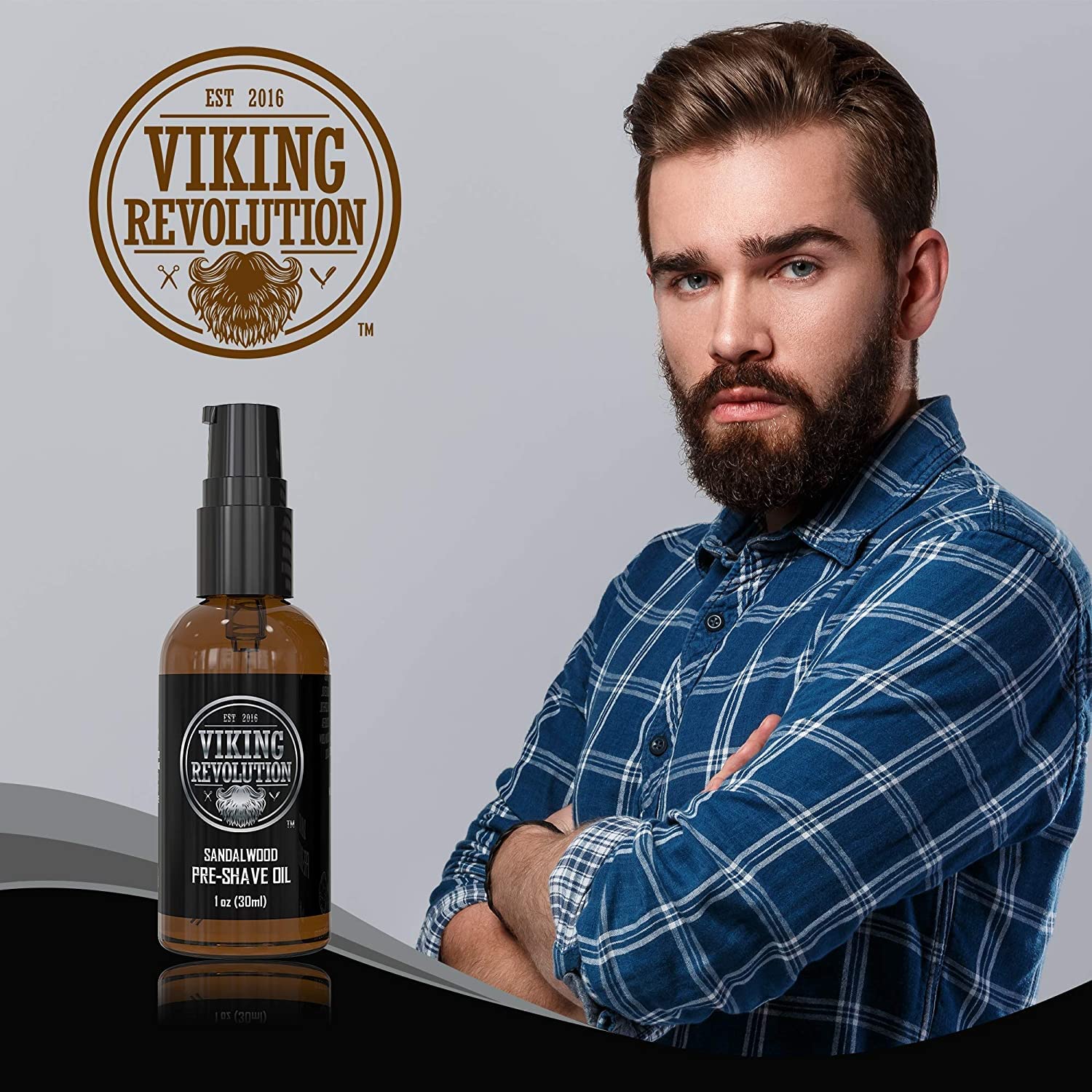 A man in a plaid shirt stands next to a bottle of Sandalwood Pre-Shave Oil, featuring a striking Viking icon on its label. The sandalwood scent promises an invigorating experience, ensuring a clean shave every time.