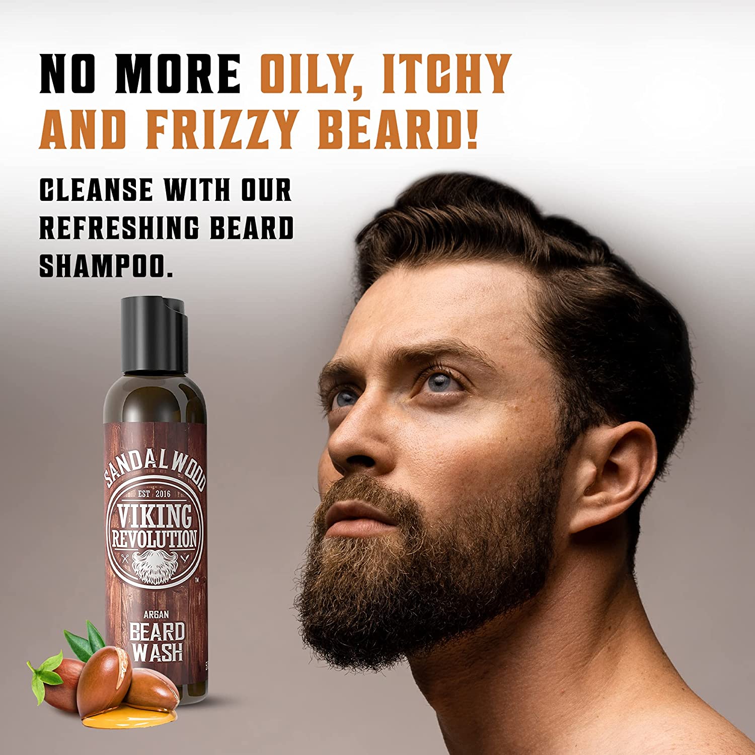 A bearded man gazes thoughtfully upward, with a bottle of Sandalwood Beard Wash & Conditioner Set - 5oz by his side. Enriched with all-natural ingredients and a sandalwood aroma, this set not only revitalizes but also encourages healthy beard growth.