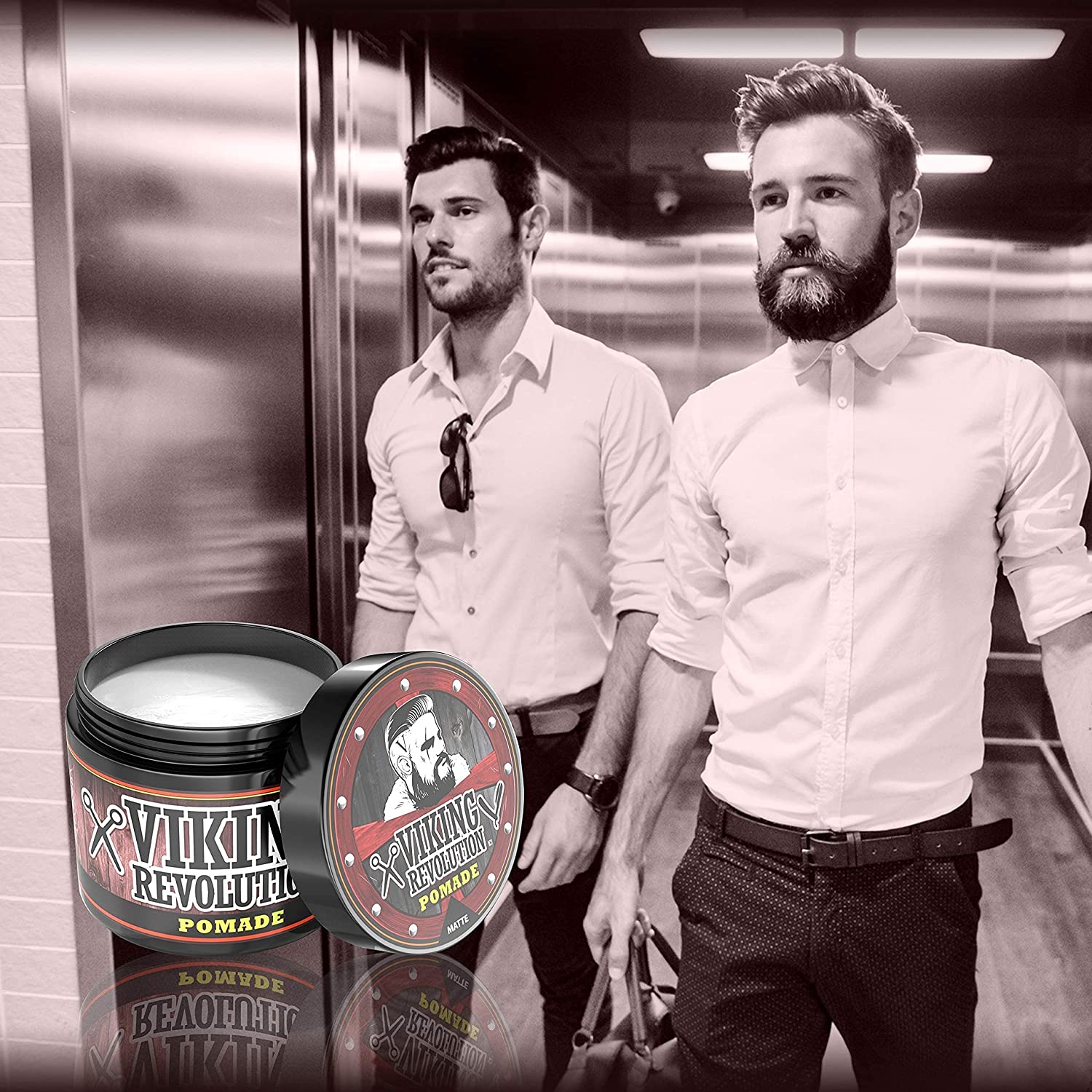 Two men stand in an elevator, with the Medium Hold Hair Pomade 4oz by Viking Revolution prominently displayed in the foreground, offering a natural matte finish.