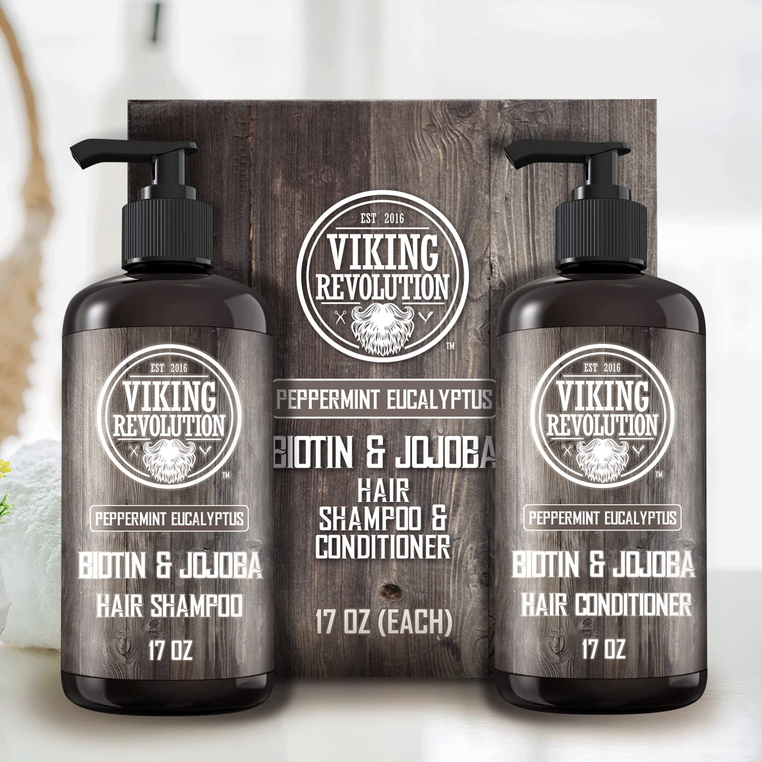A pair of Eucalyptus and Peppermint Shampoo and Conditioner Sets (17 Oz) on a rustic wood background.