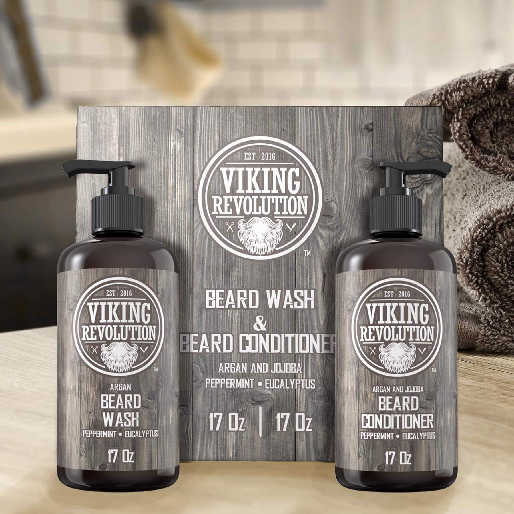 The Beard Wash & Conditioner bottles from Viking Revolution, enriched with all-natural ingredients, rest elegantly on a bathroom counter, offering nourishing care for facial hair.