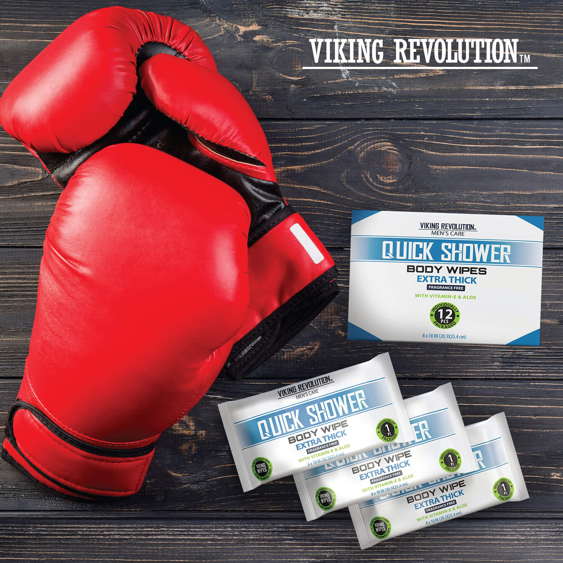 Red boxing gloves and Viking Revolution Body Wipes w/ Vitamin E & Aloe on a wooden surface.