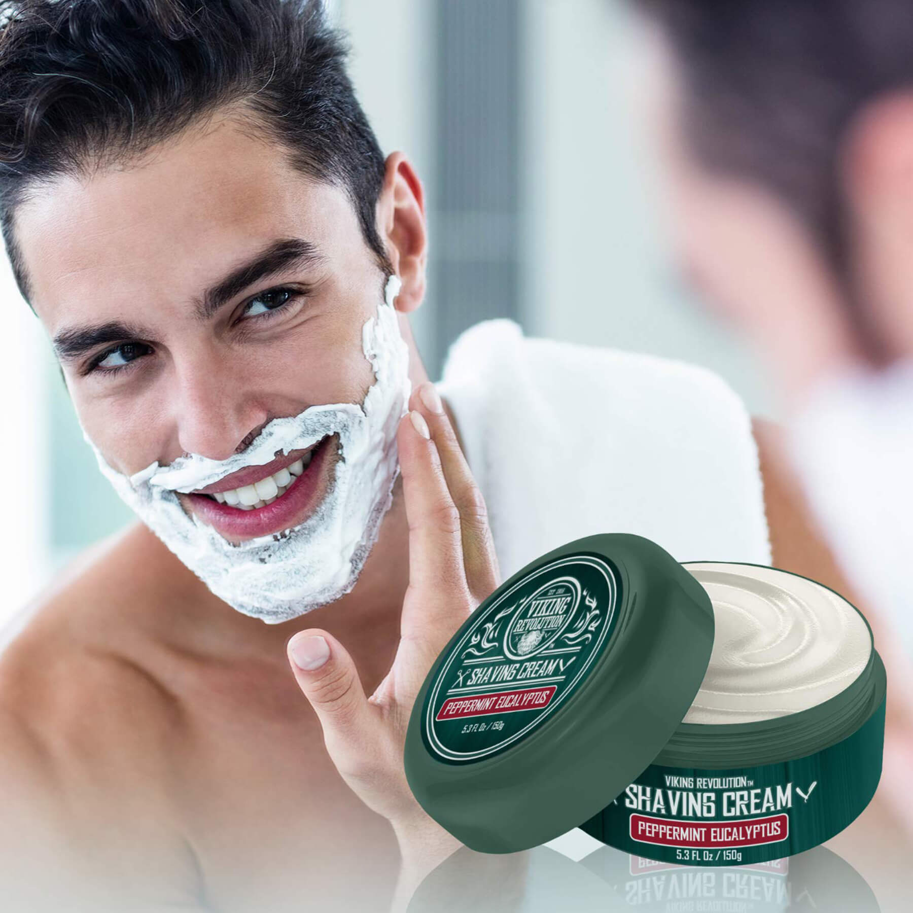 A man smiling as he enhances his shaving experience by applying the Peppermint & Eucalyptus Shaving Cream in front of the mirror.