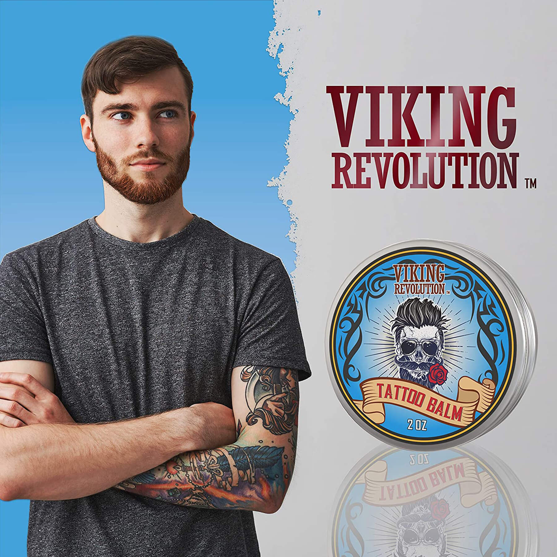 A tattooed, bearded man stands beside a tin of Tattoo Care Balm - 2 Pack, prepared to moisturize and soothe for optimal tattoo healing.