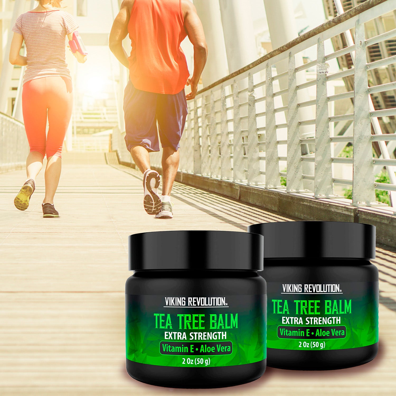Two jars of Tea Tree Oil Cream - 2 Pack on a sunlit boardwalk with joggers in the background.