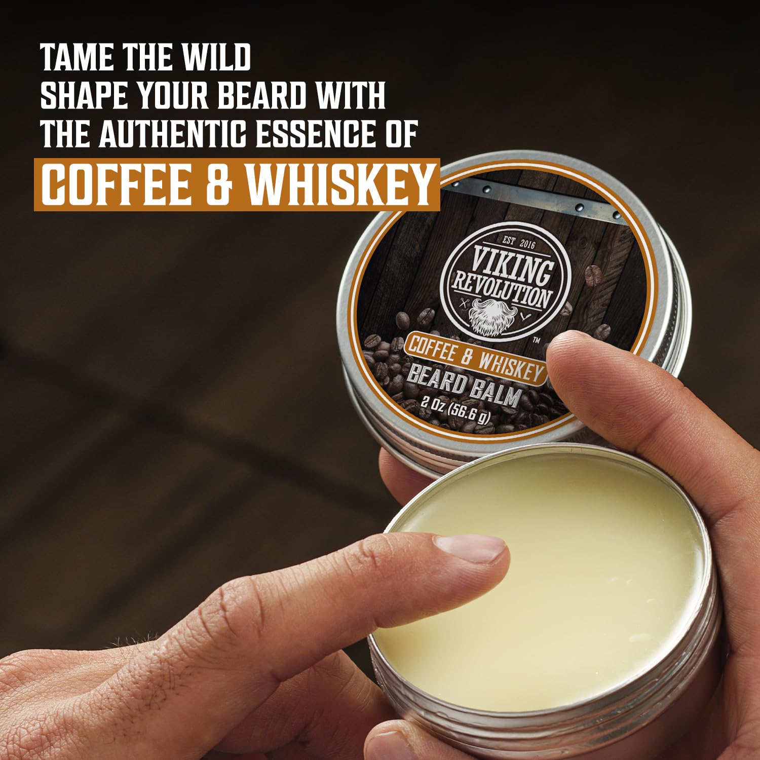 Man opening Coffee and Whiskey Beard Balm, ready to use the kit for ultimate beard care.