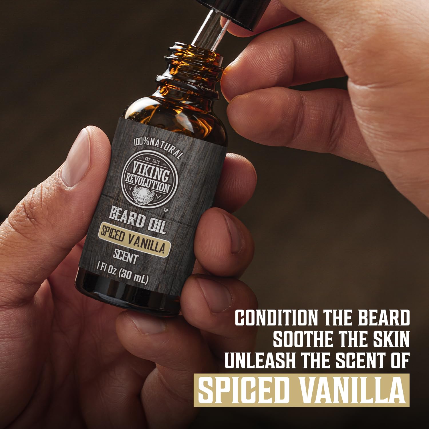 Hand holding a Spiced Vanilla Beard Balm & Beard Oil Kit from Viking Revolution for premium beard care.