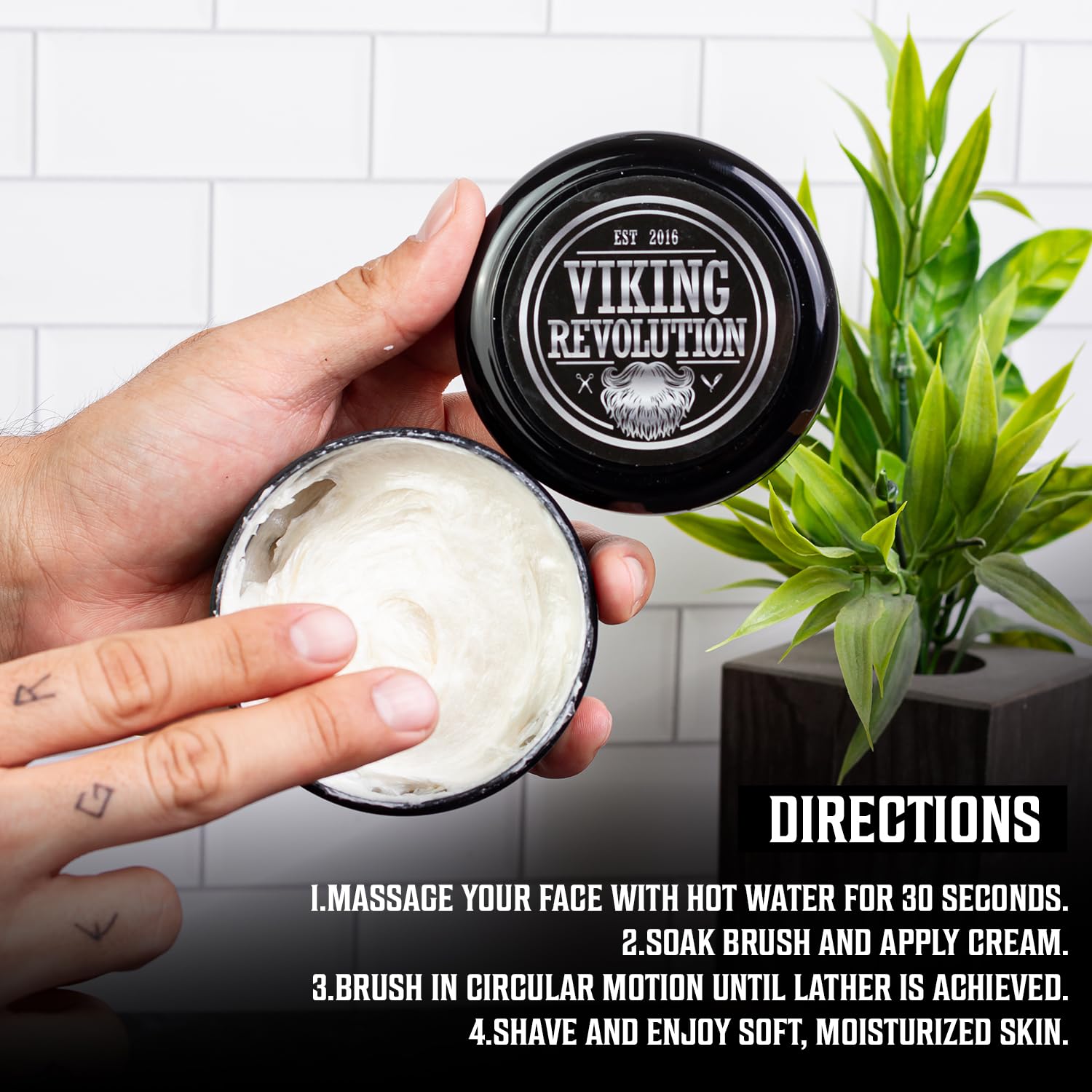 A hand holds Sandalwood Shaving Cream (5.3oz), directions visible beside a potted plant.