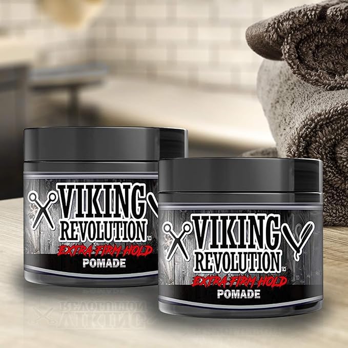 Two jars of Extreme Hold Hair Pomade - 2 Pack sit on a bathroom counter near some towels.