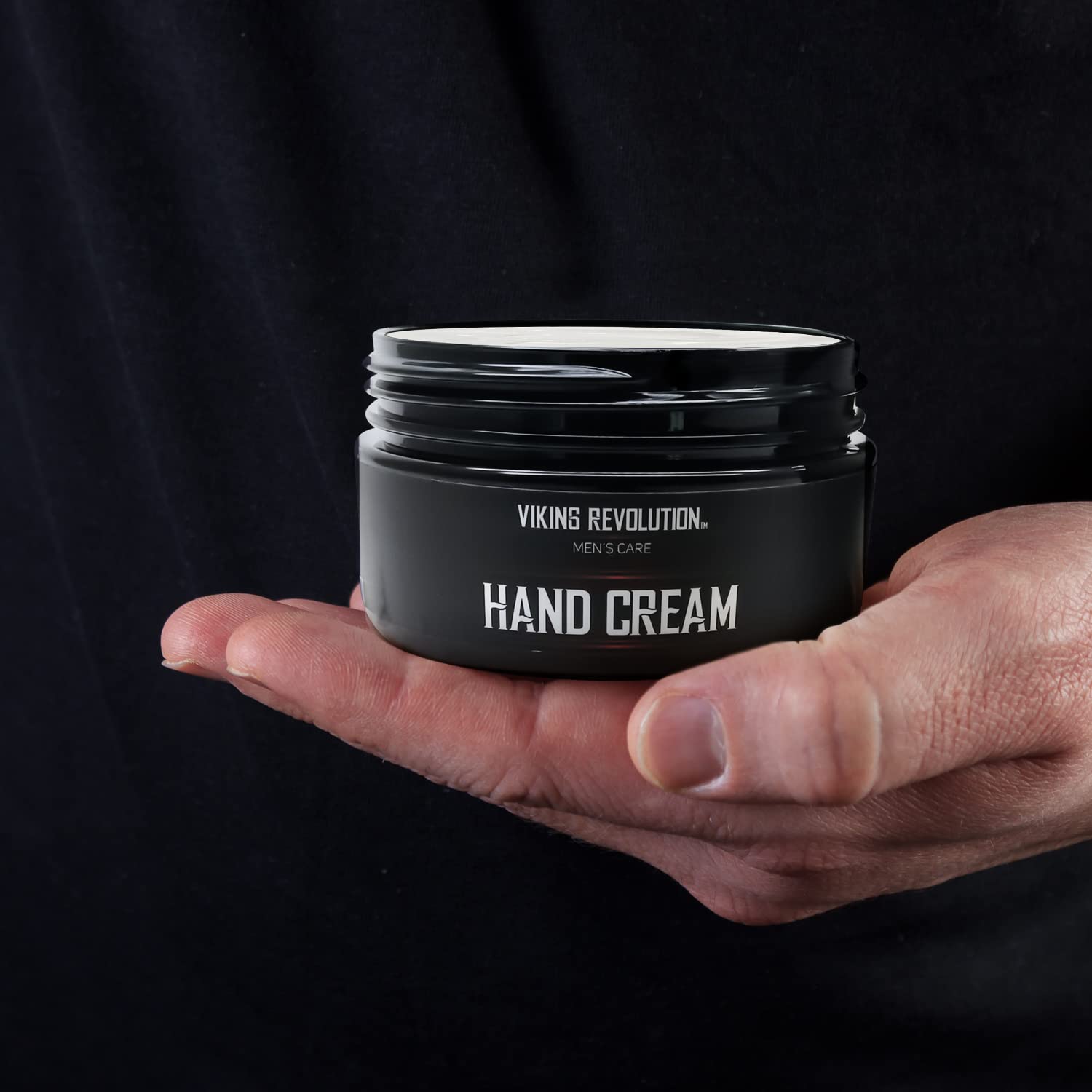 A hand holds an open Hand Cream - Extreme Relief for dry, cracked hands.