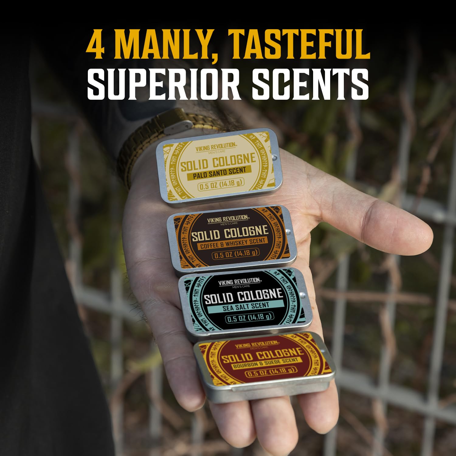 A hand holds the Viking Revolution 4 Pack Solid Cologne for Men travel set outdoors.