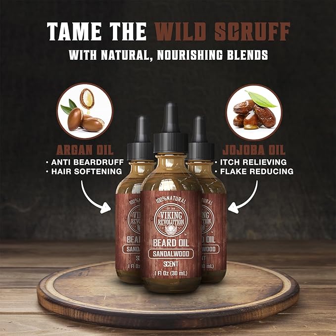 Three bottles of Sandalwood Beard Oil rest on a wooden surface, releasing a gentle sandalwood scent. Labels above each bottle emphasize the benefits of their 100% natural argan and jojoba oils, including their ability to tame stubborn facial hair.