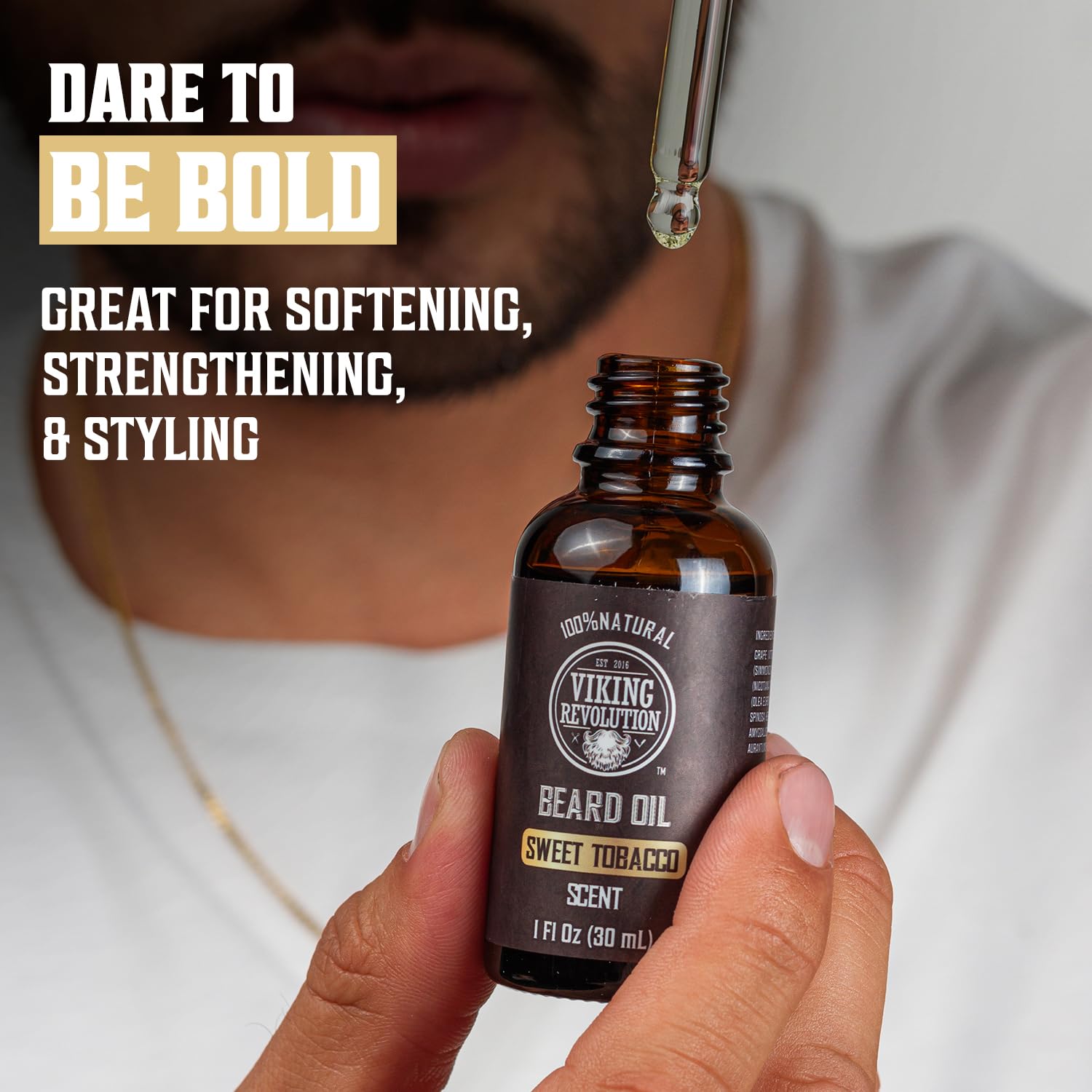A bearded man holds a pipette and a bottle of Tobacco Beard Oil for Men - 1 Pack, embodying natural beard care with its sweet tobacco scent. Perfect for taming stubborn facial hair.