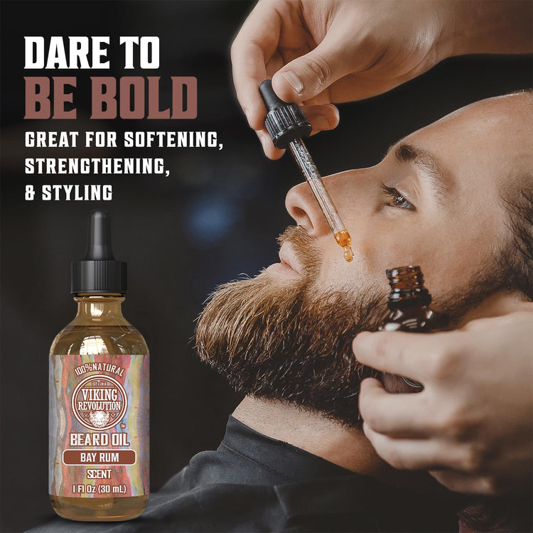 Using a dropper, a man applies Bay Rum Beard Oil by Viking Revolution to promote softening, strengthening, and styling for optimal beard maintenance.