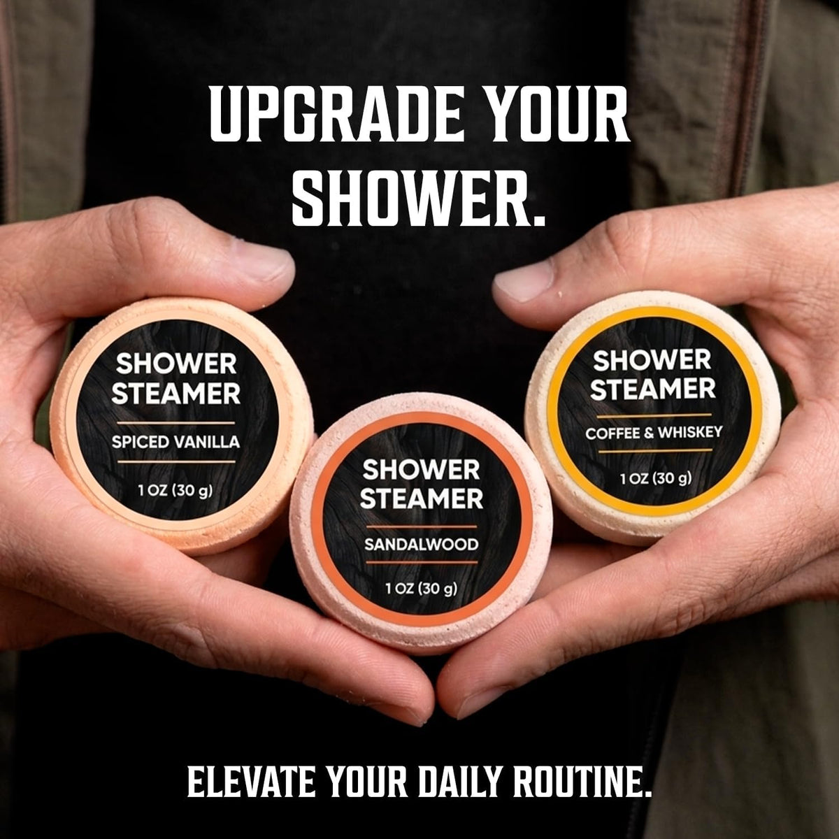 Hands holding three Shower Steamers for Men labeled Spiced Vanilla, Sandalwood, and Coffee & Whiskey.