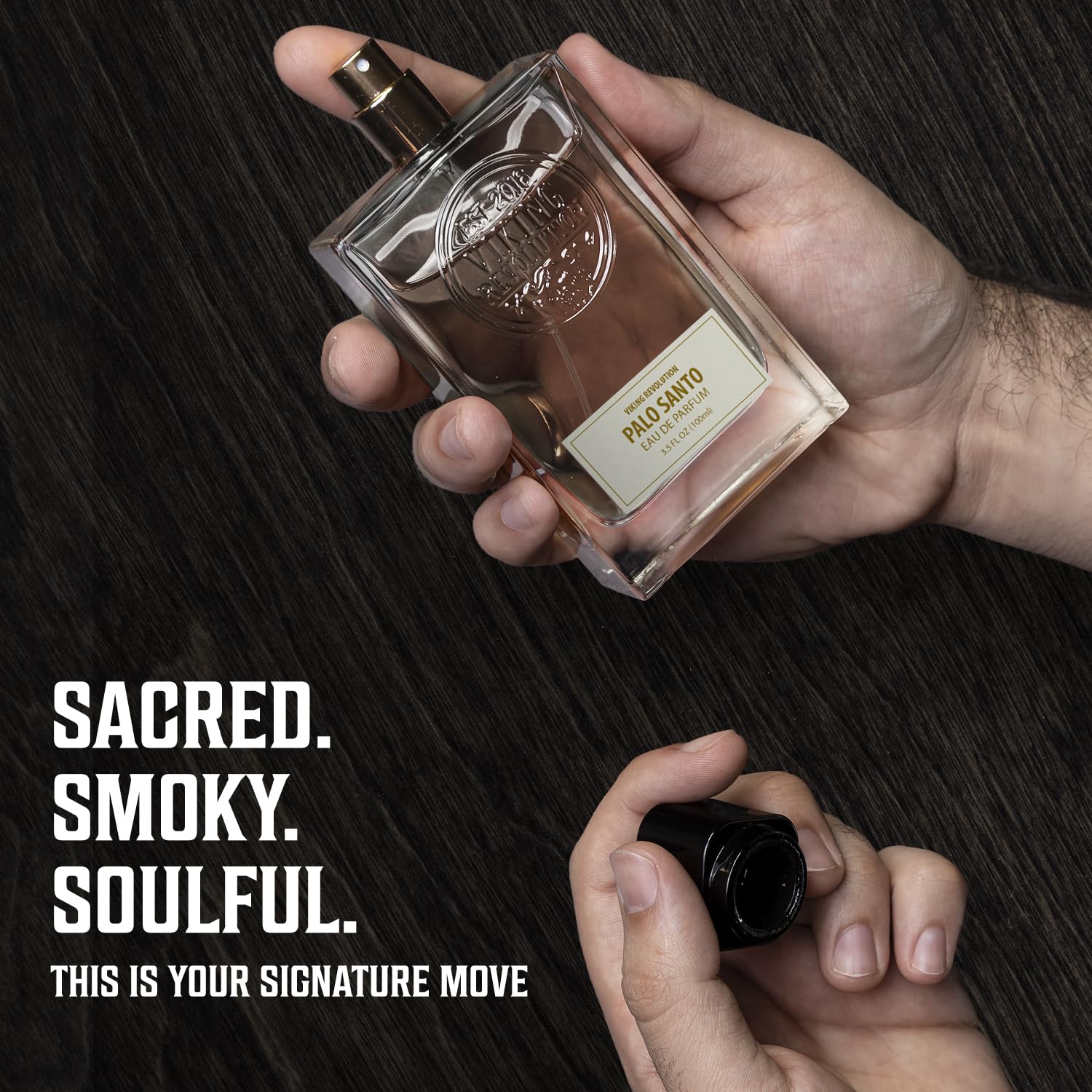 A hand sprays Palo Santo Eau de Parfum 3.4 Fl Oz: sacred, smoky, soulful—a bold men's fragrance.